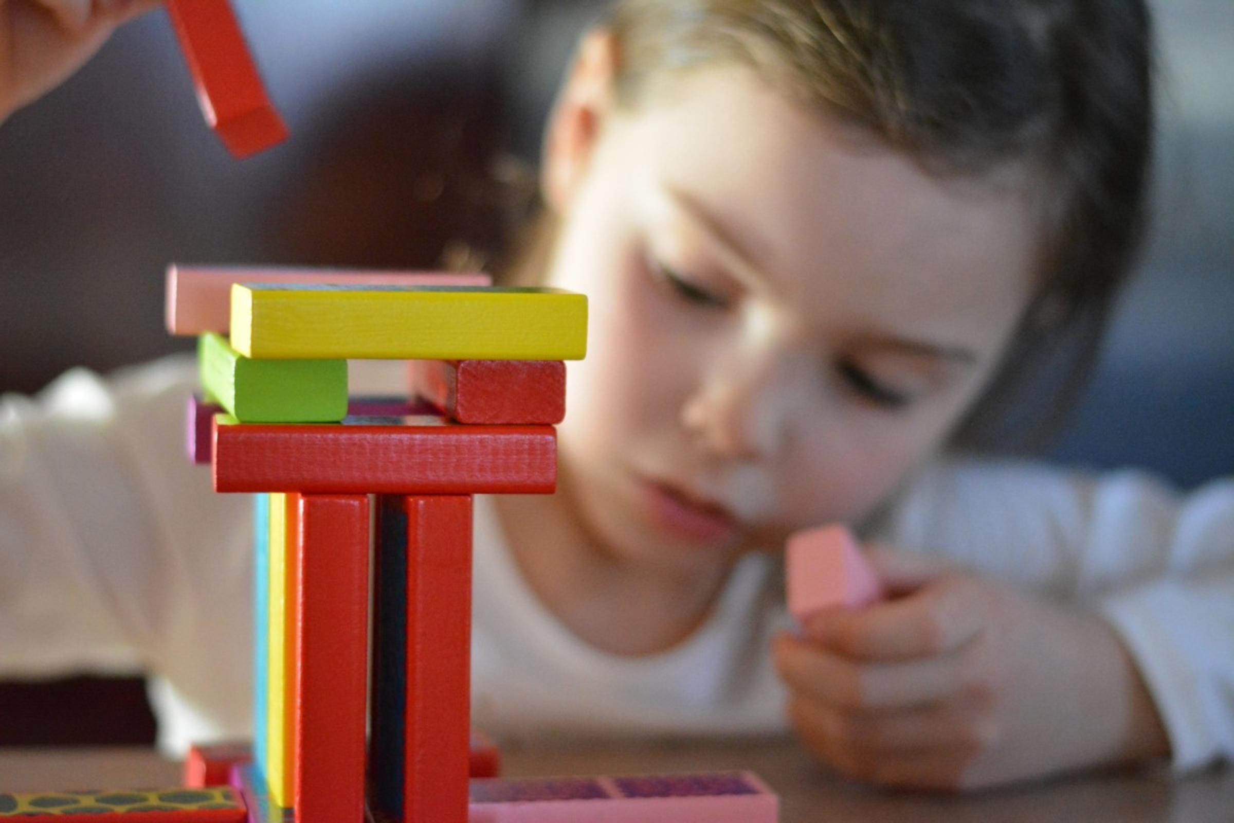 girl playing with Jenga blocks