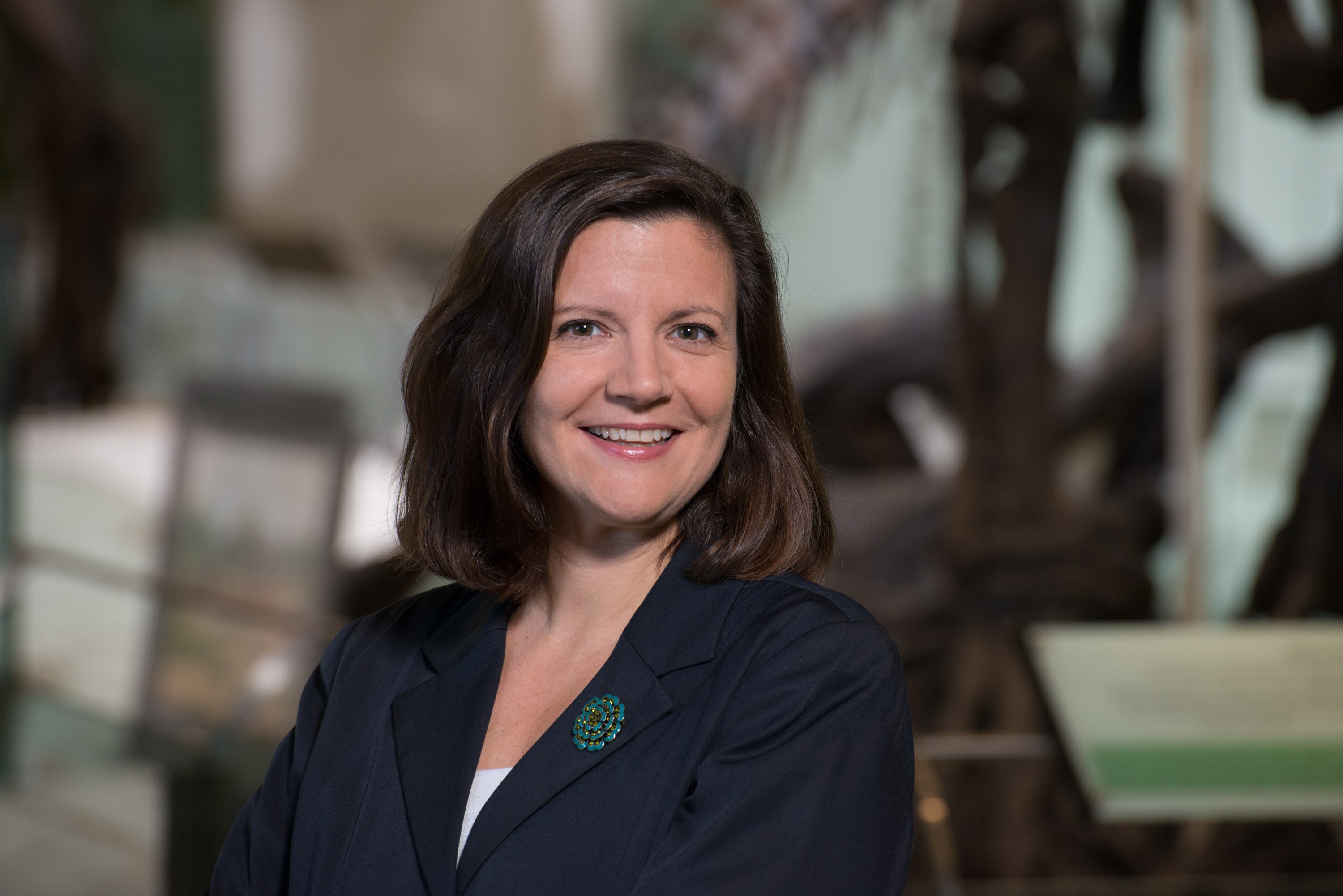 A headshot of Laura Rose in a blue blazer