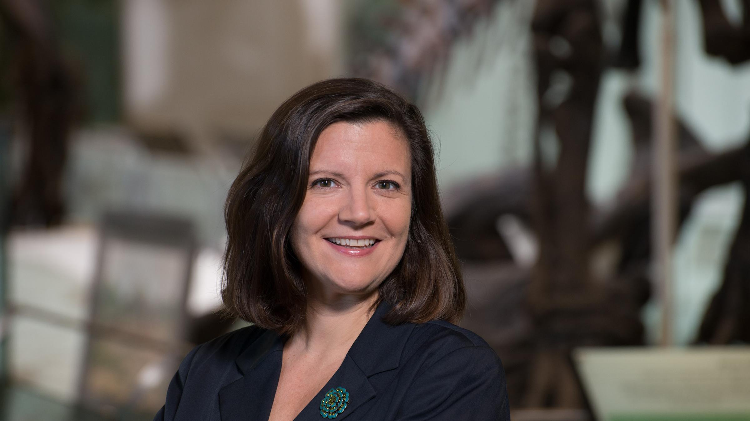 A headshot of Laura Rose in a blue blazer