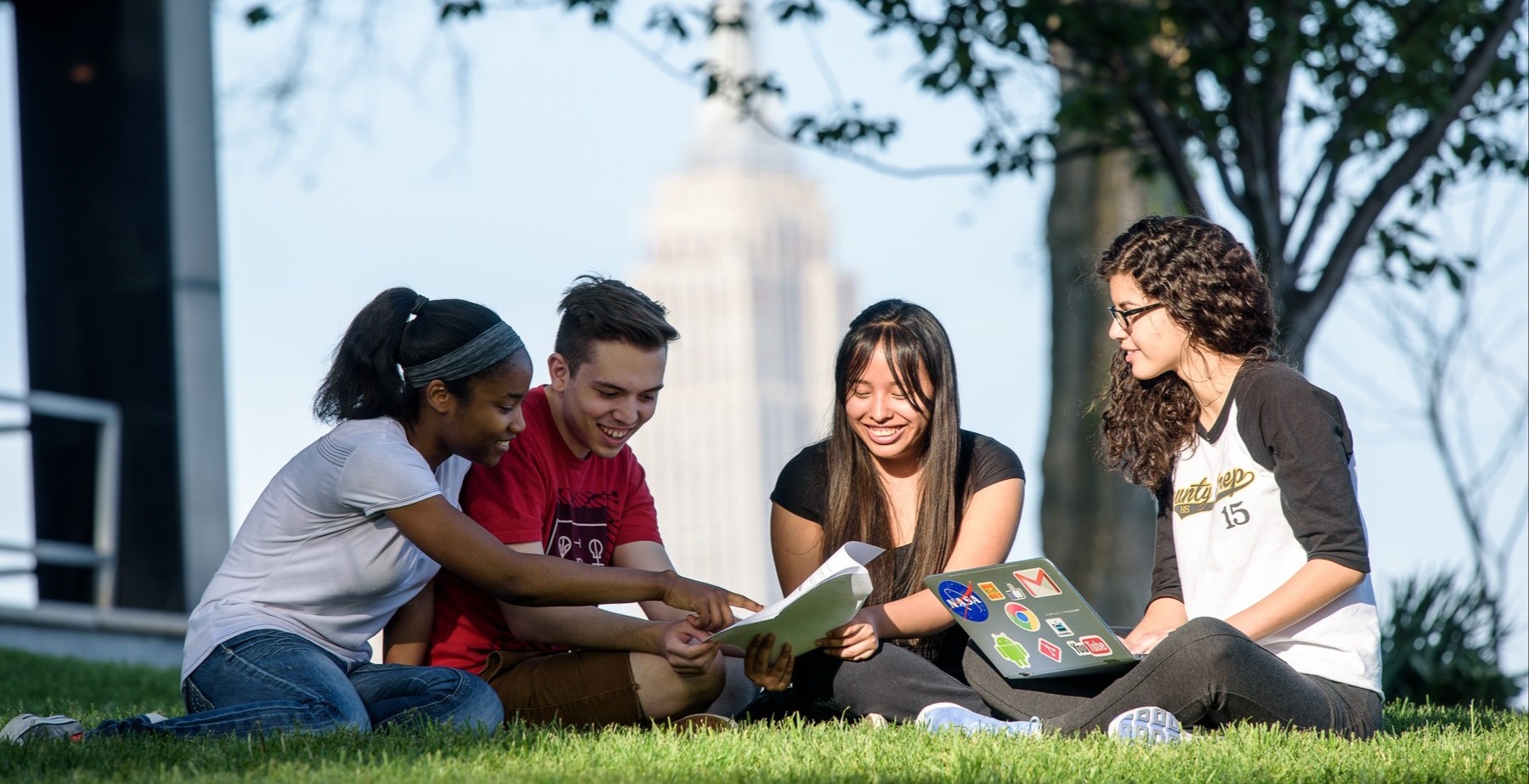 students sitting outside on campus