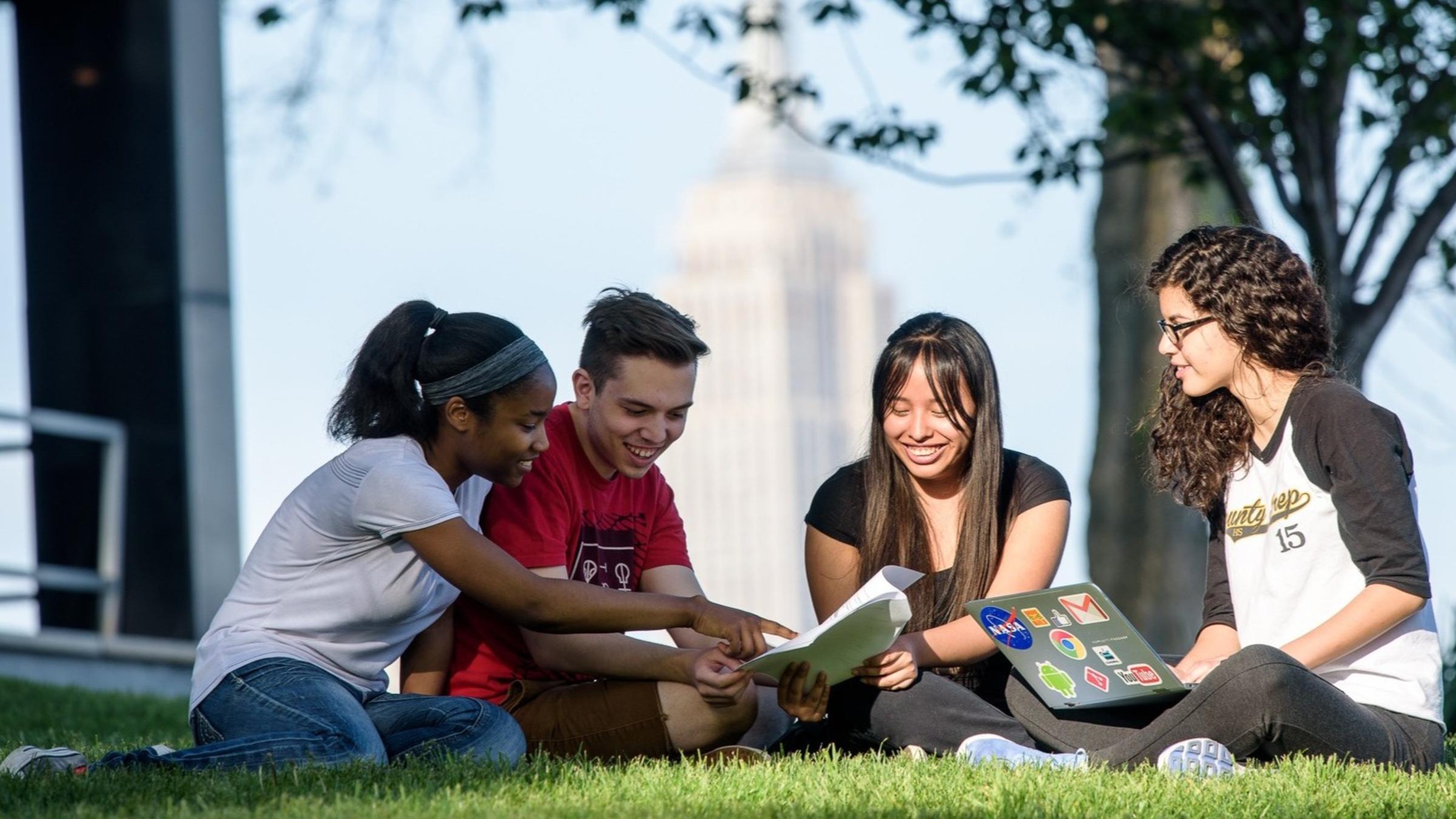 students sitting outside on campus