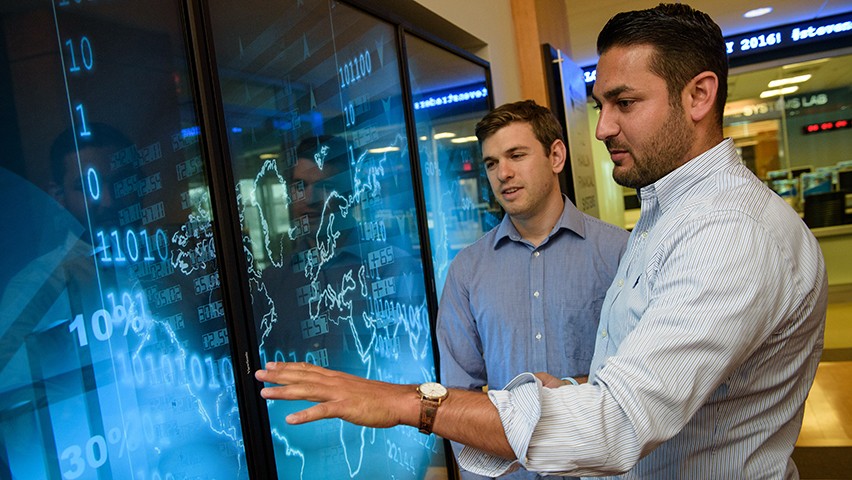 Students working with a digital display in class. 