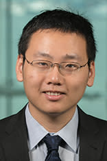 Dr. Feng Mai with the New York City skyline in the background.
