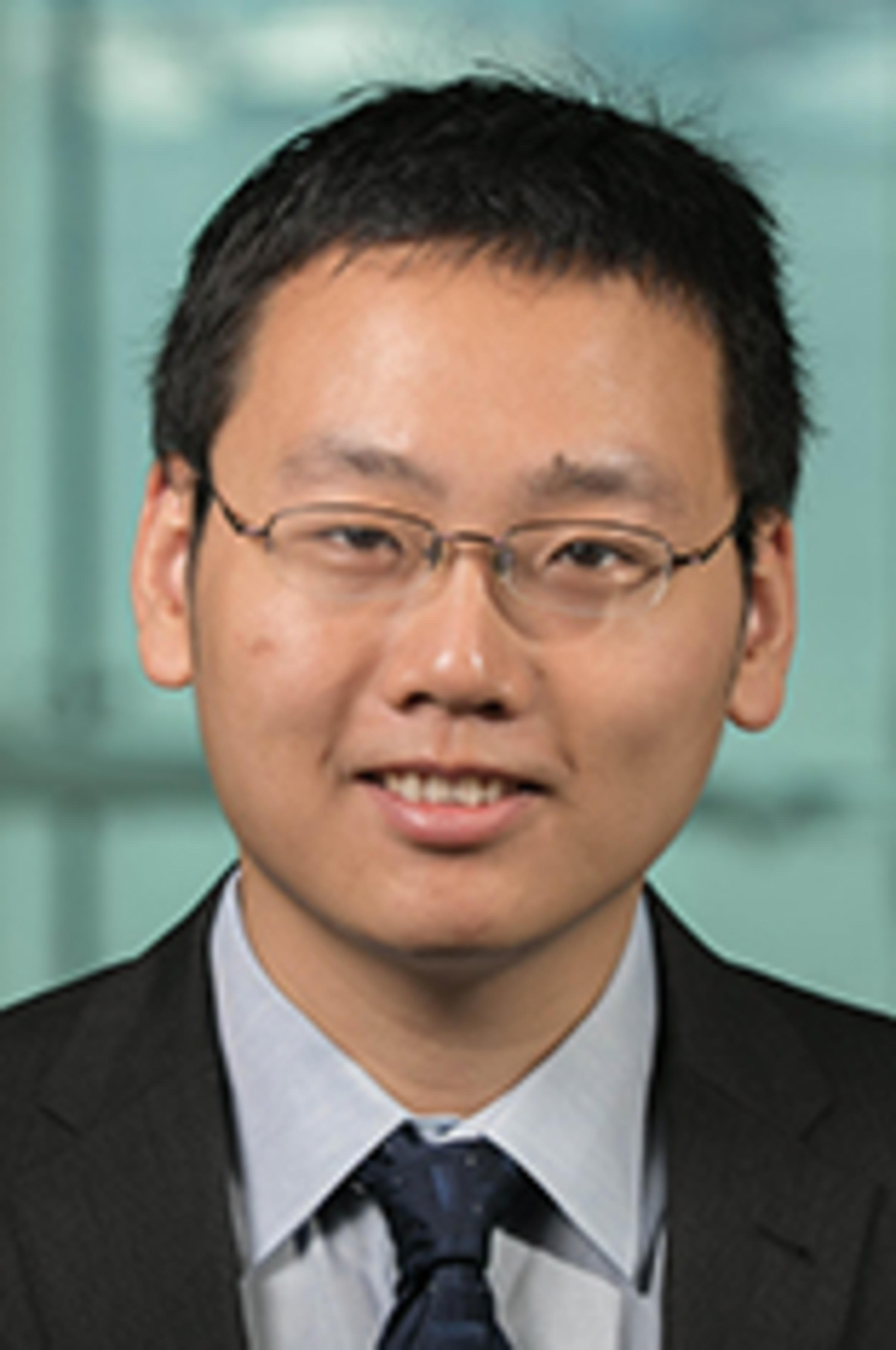 Dr. Feng Mai with the New York City skyline in the background.