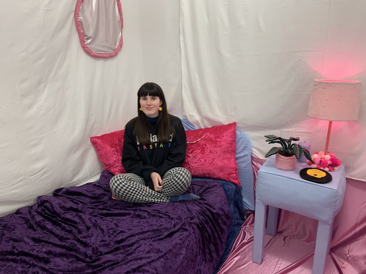 Kelly McGowan seated inside her art installation