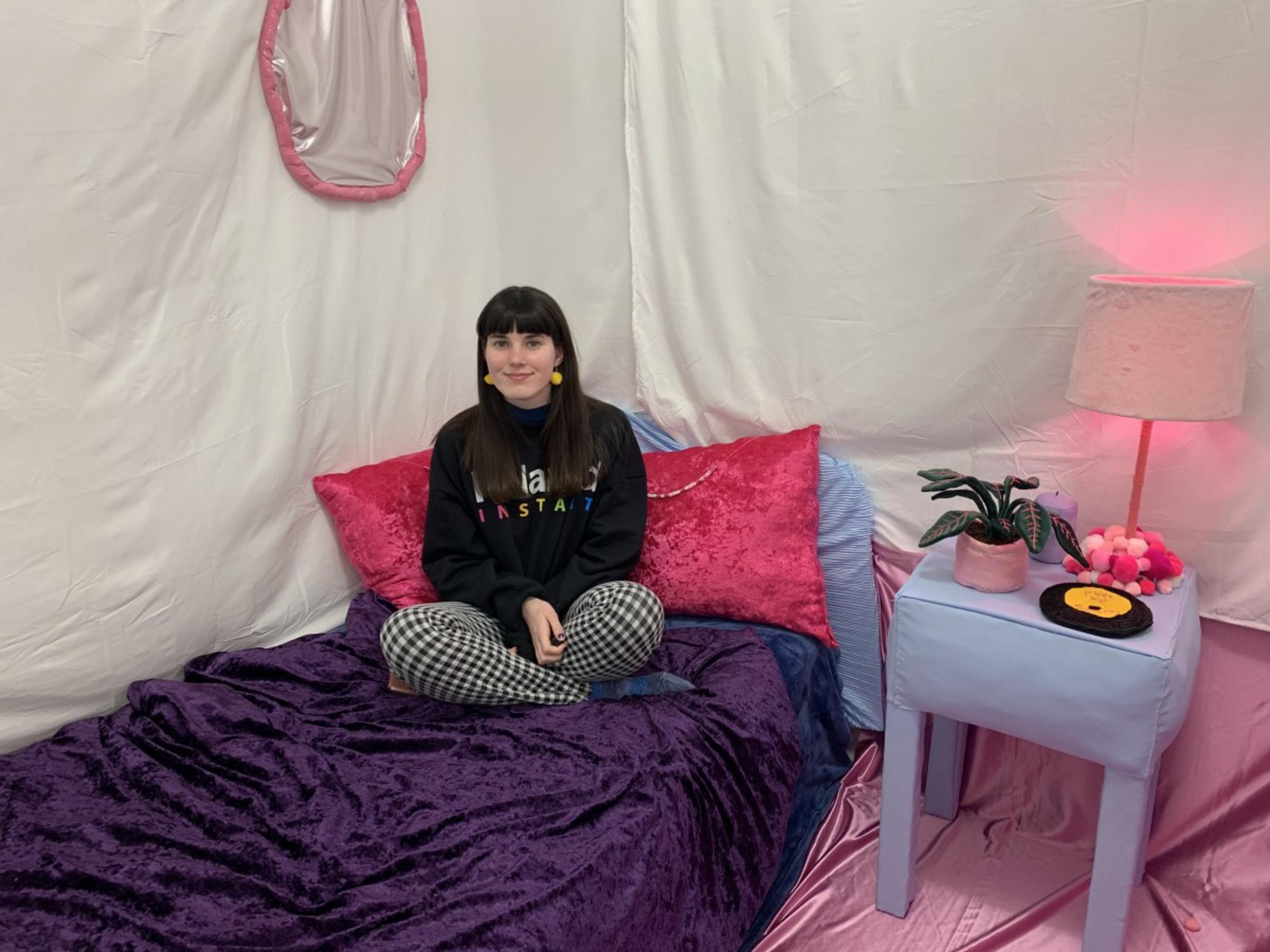 Kelly McGowan seated inside her art installation