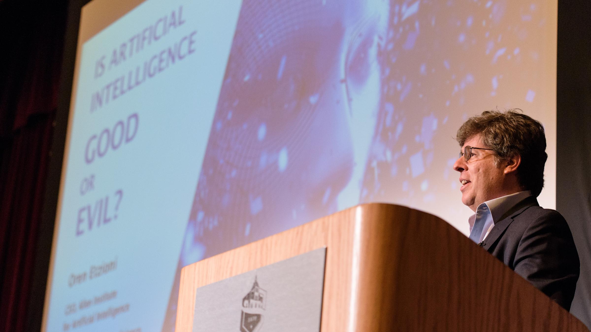 Oren Etzioni standing at the podium at DeBaun Auditorium