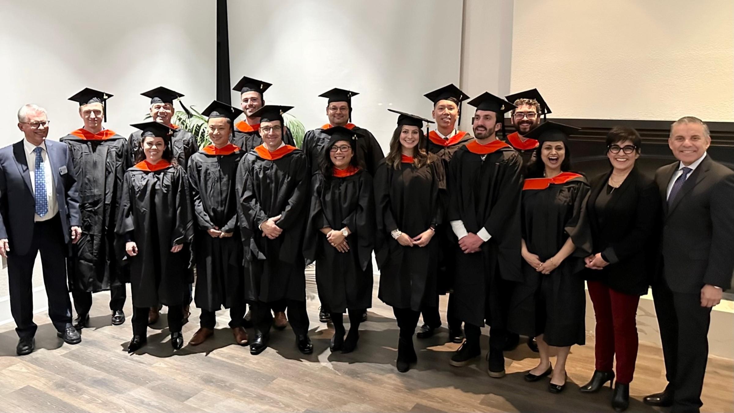 Graduates from Northrup Grumman wearing caps and gowns.