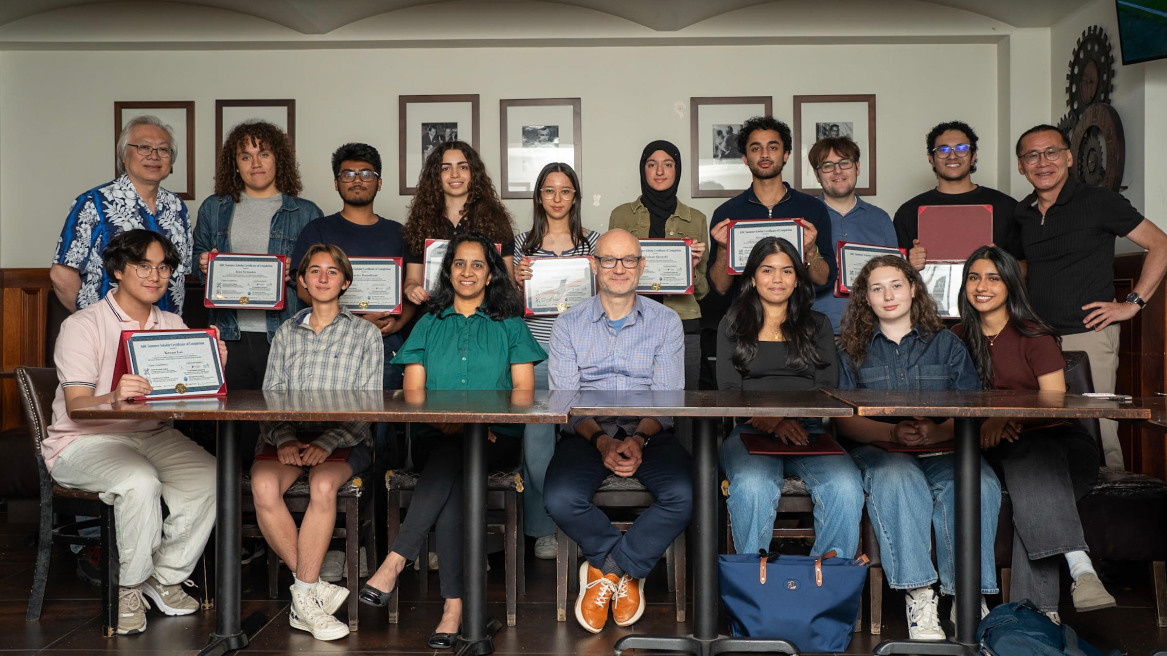 Faculty members Kenny Wong (first, standing left), Sesha Sridevi Alluri and Marcin Iwanicki (seated third and fourth from left) and Woo Lee (standing, first at right) post with AiBC scholar stduents..
