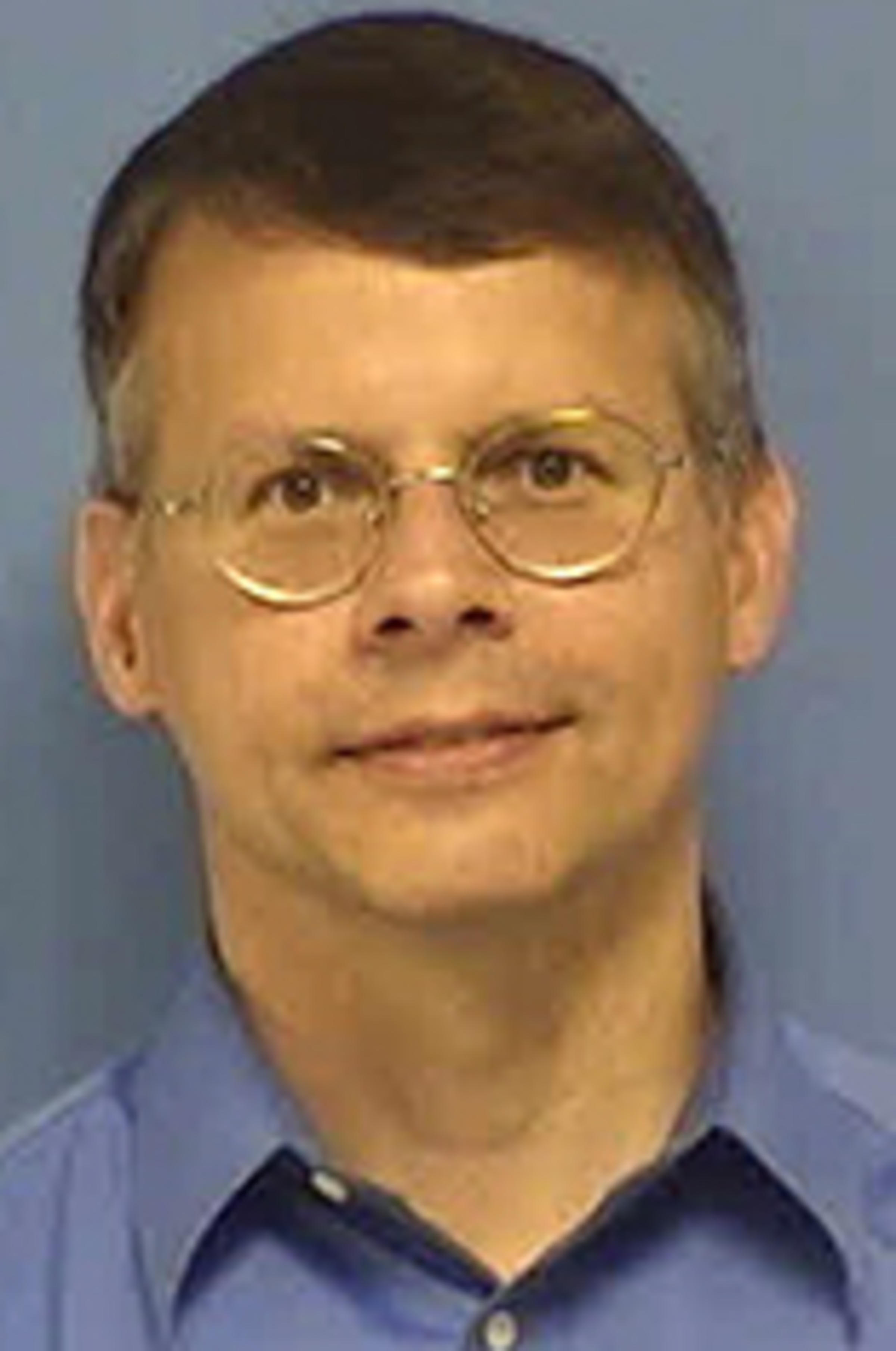 Headshot of Robert Zotti against a blue backdrop.