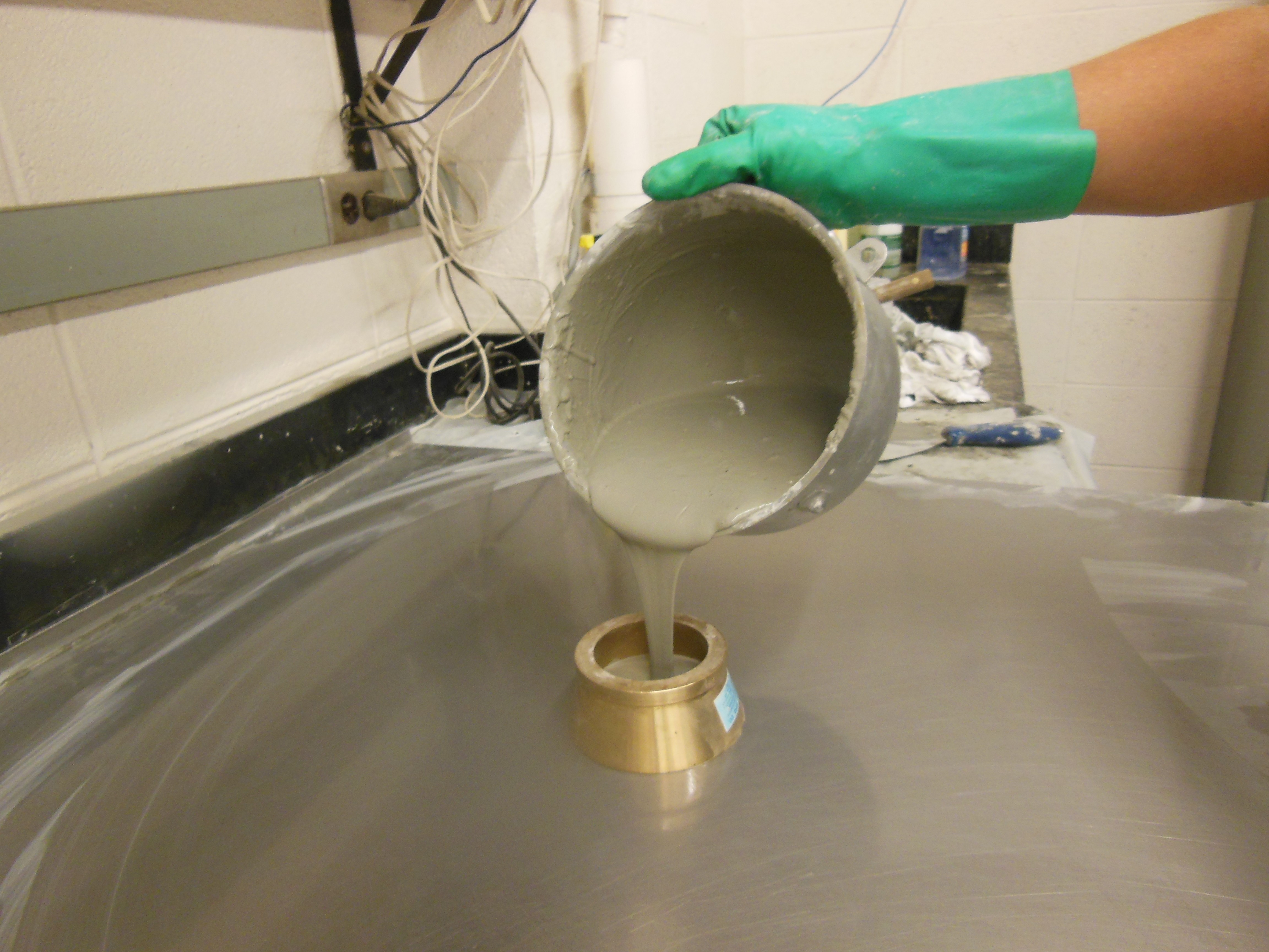 Concrete being poured from a bowl
