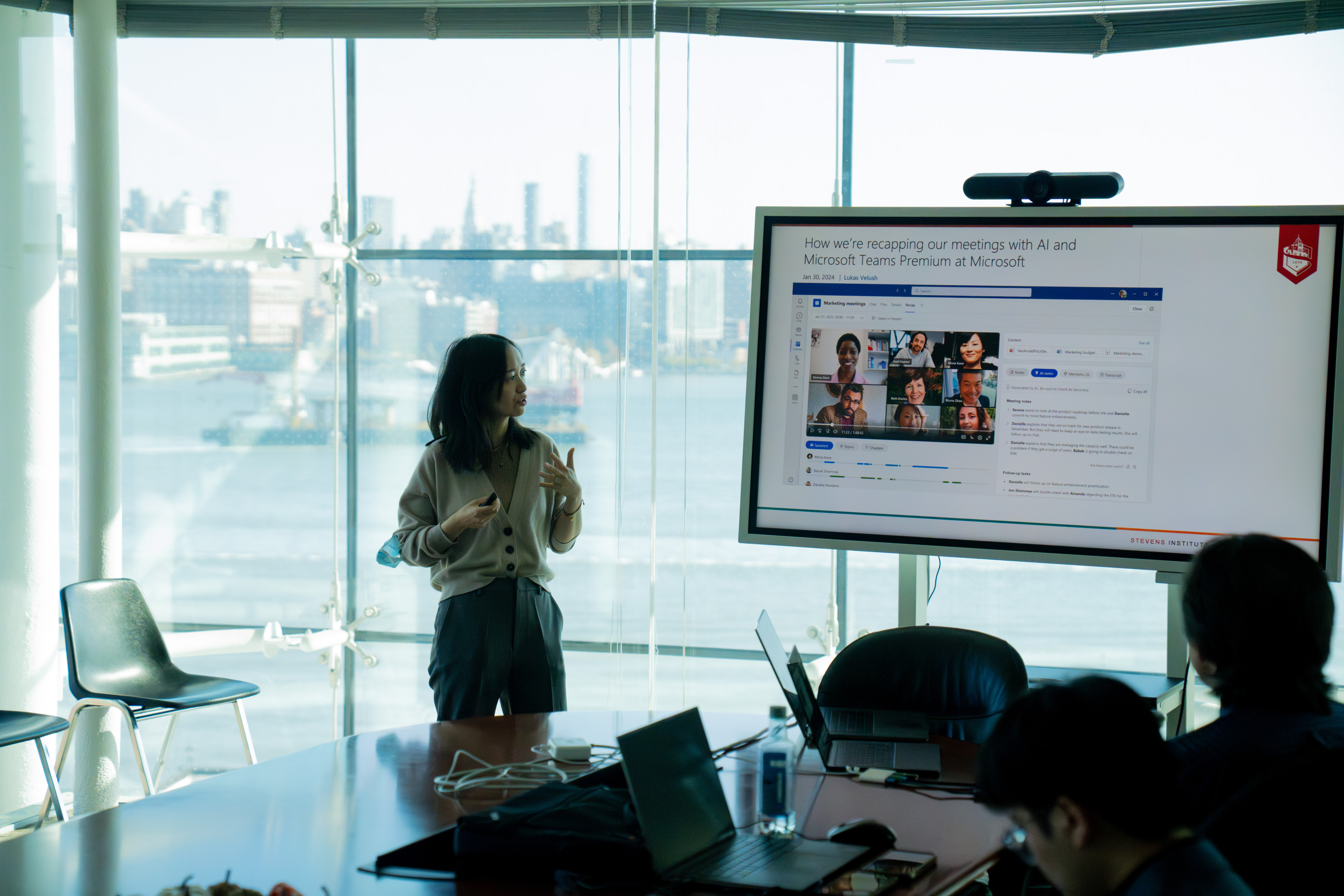 Bei Yan presents her research with part of the New York City skyline in background
