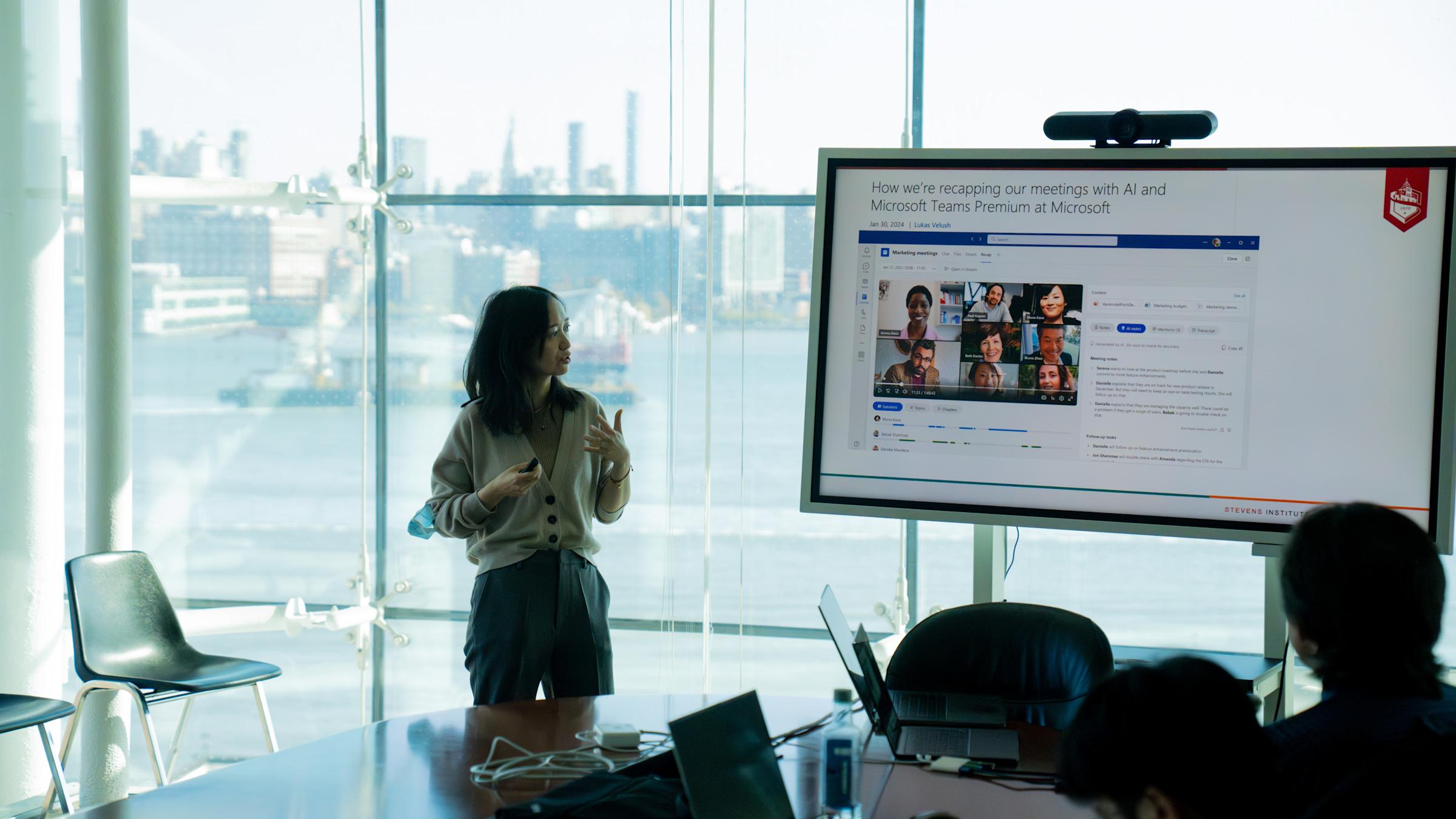 Bei Yan presents her research with part of the New York City skyline in background