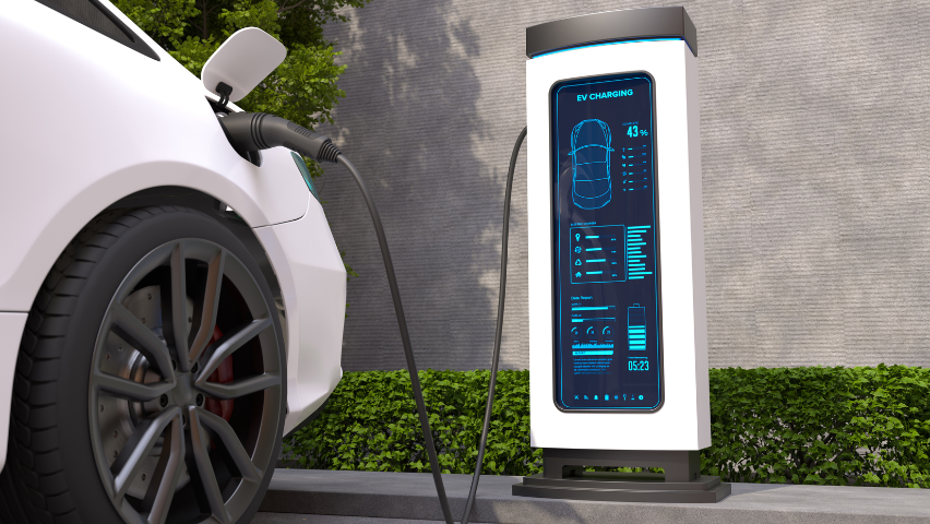 A ground, front-wheel view of a car that is charging at a charging station.