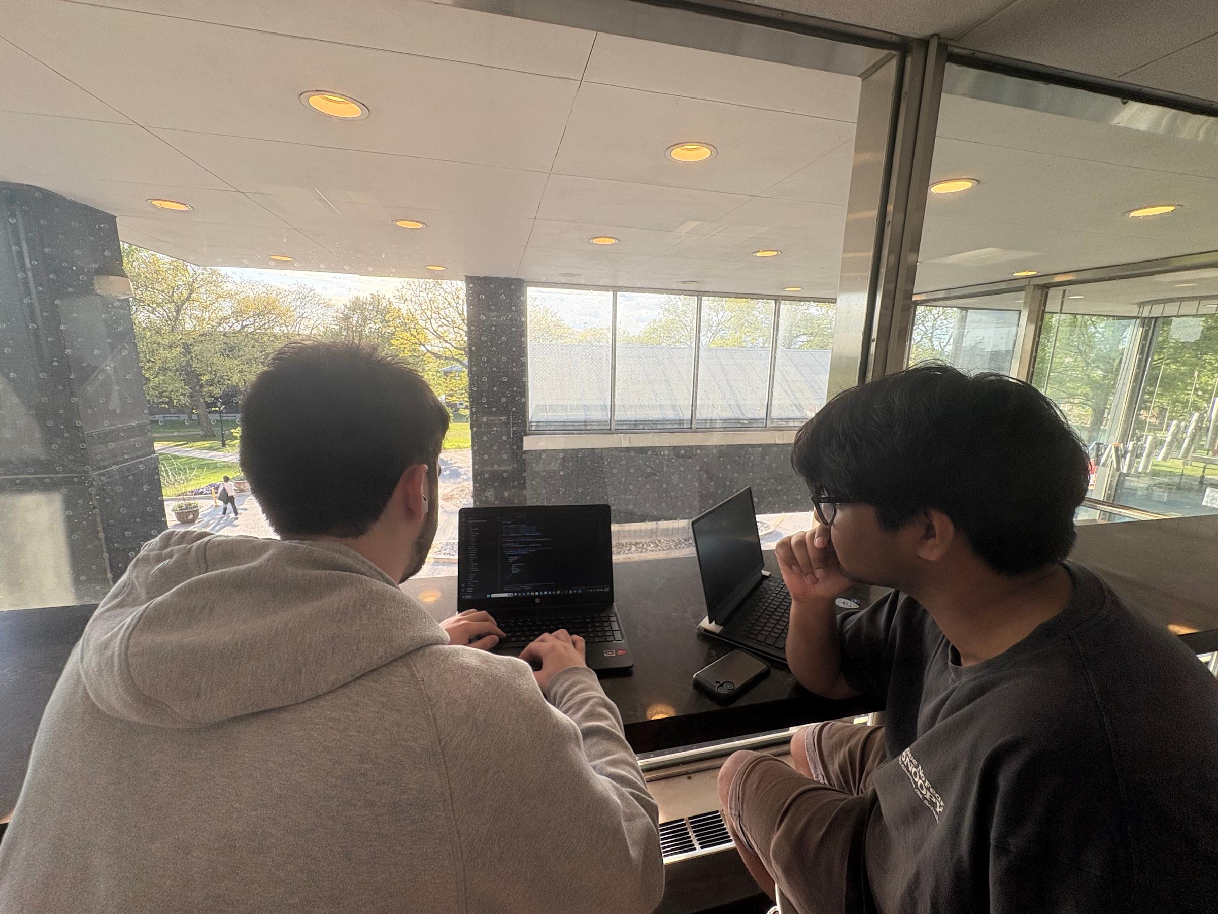 CJ Folgore, working here with Tanav Thota working on a computer screen.