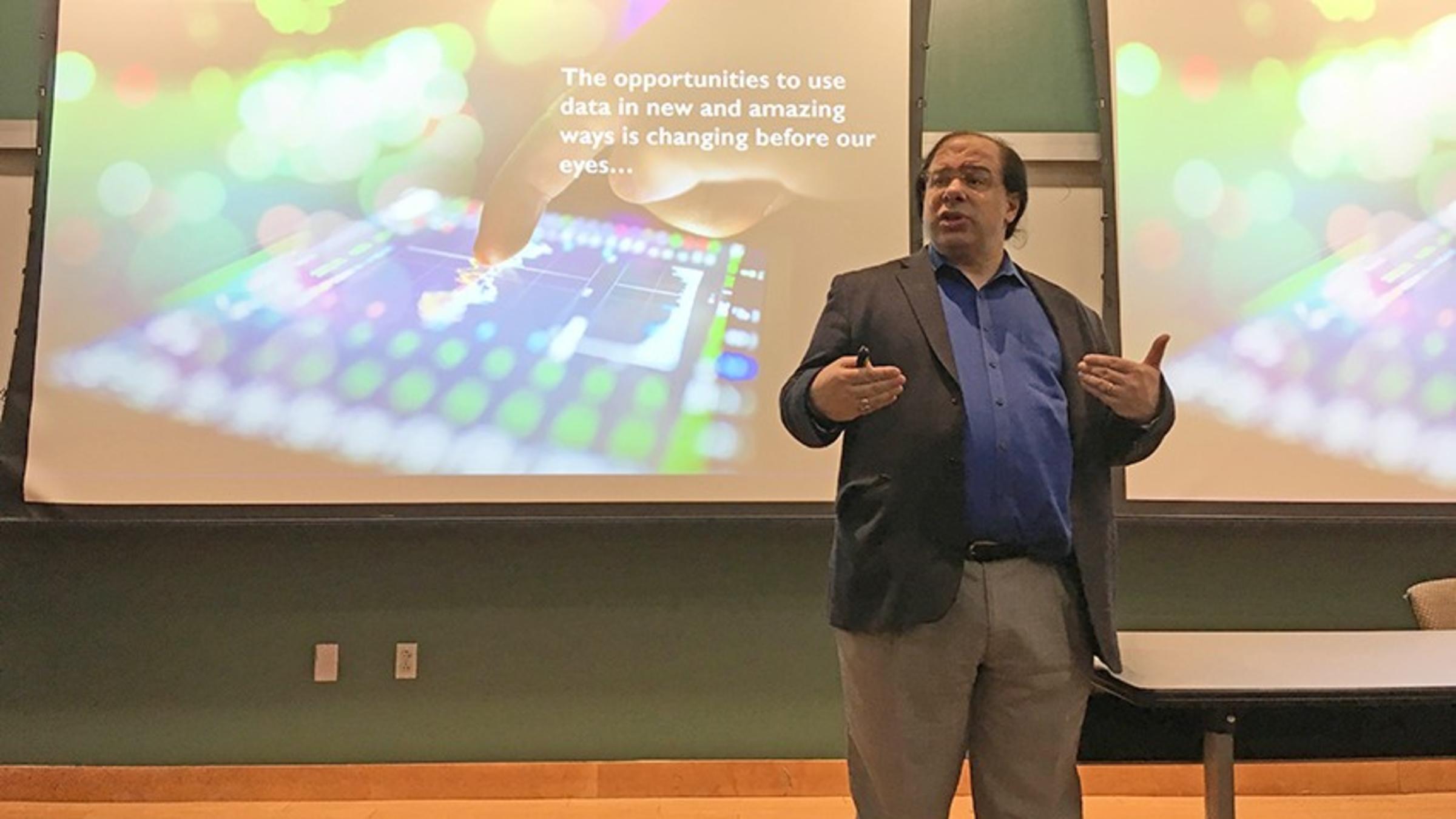 A lecturer walks the crowd through a slide deck during the talk.