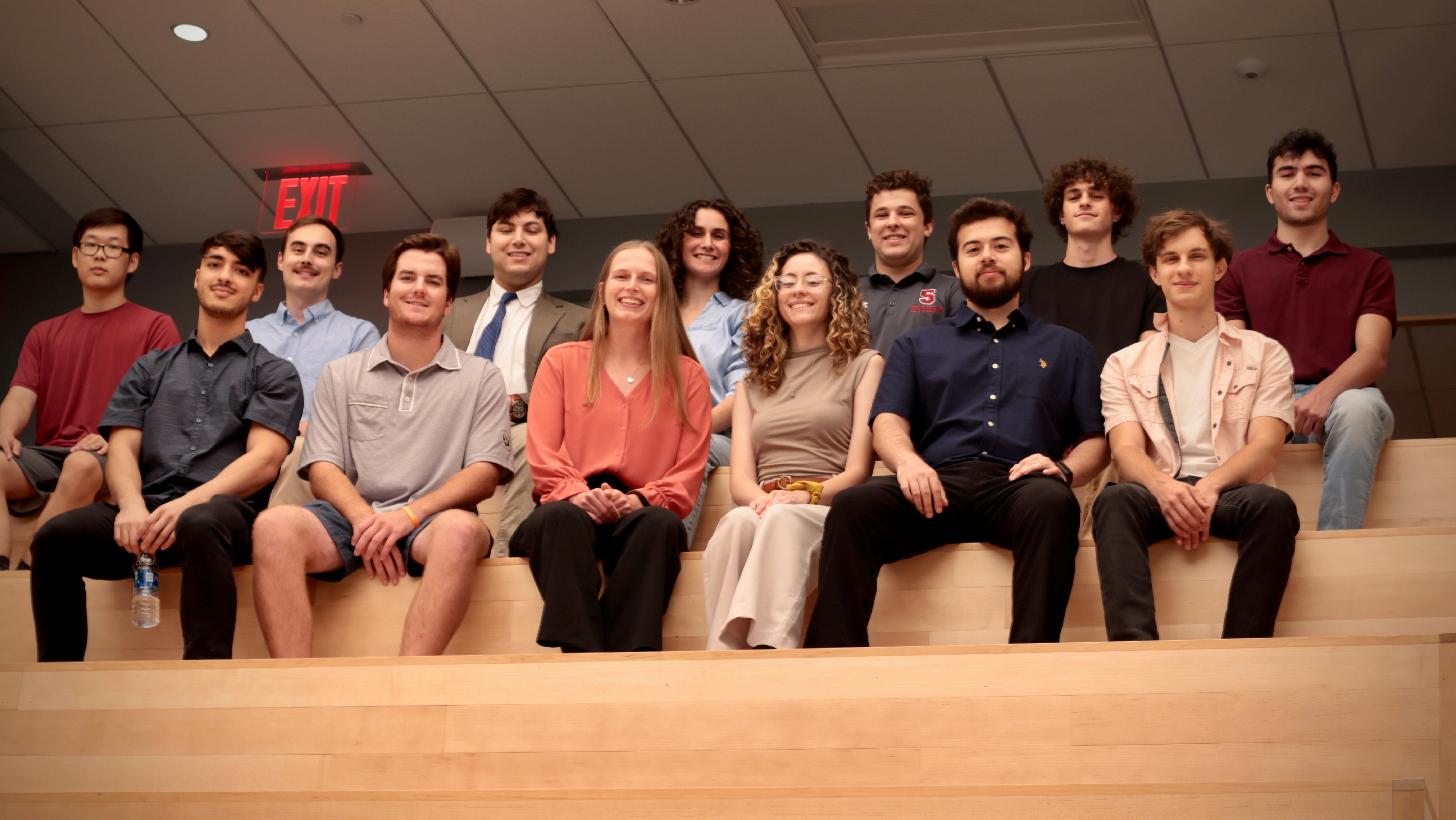 A group of thirteen students who participate in Launchpad pose for a photo together