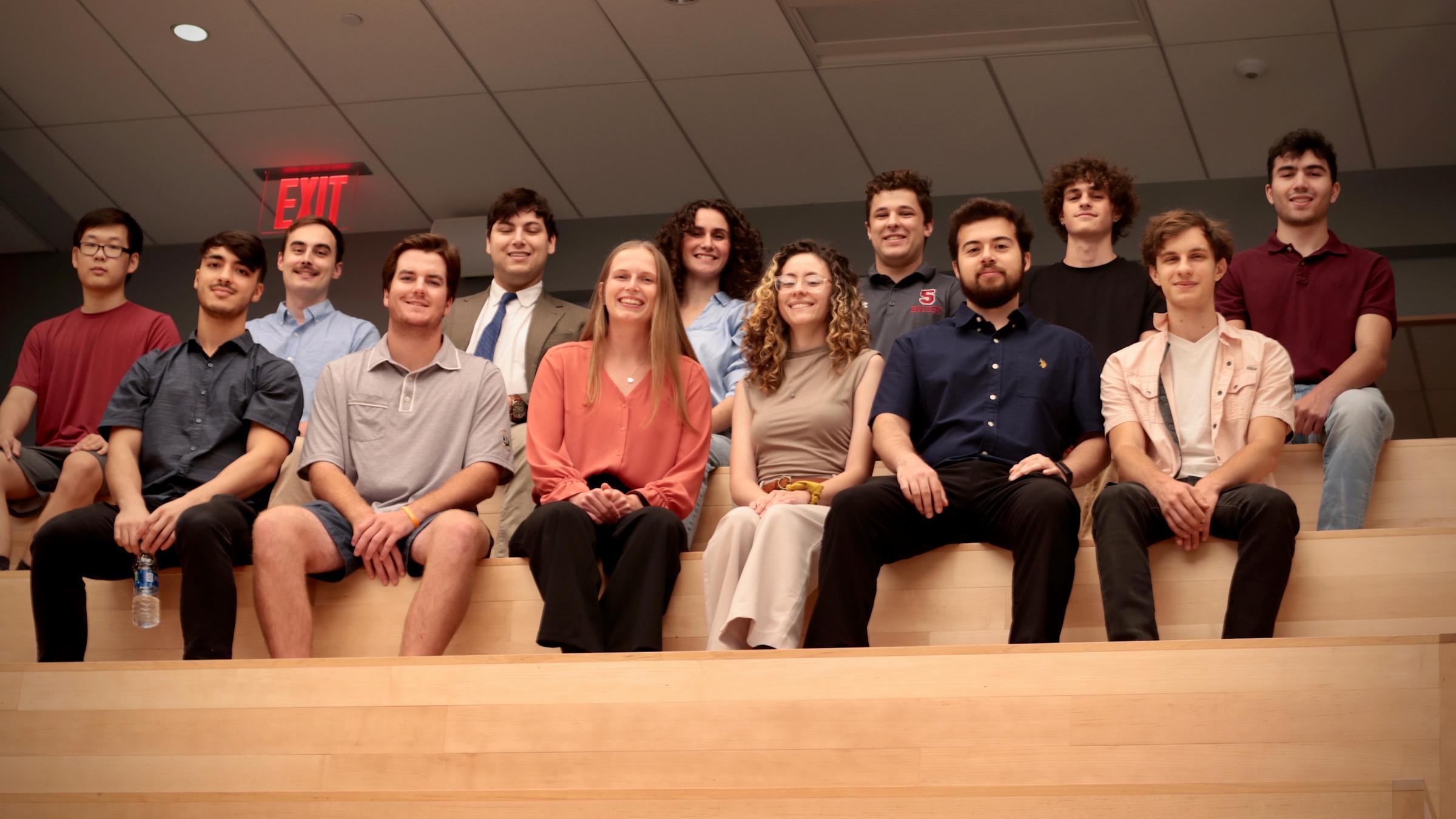 A group of thirteen students who participate in Launchpad pose for a photo together