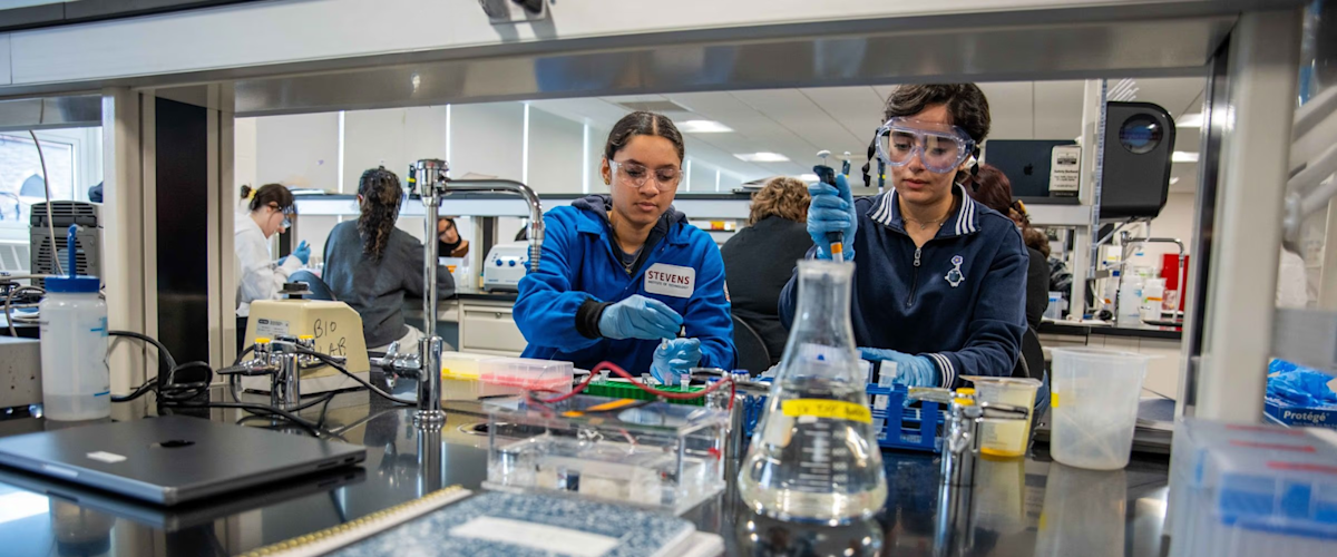 Two students wearing personal protective gear working in the newly renovated chemical biology laboratory..