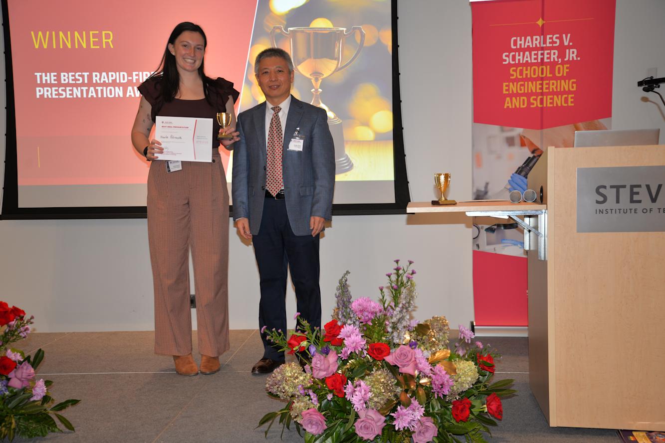 Nicole Petrocelli receives her award for best rapid-fire presentation next to CHI director Hongjun Wang.