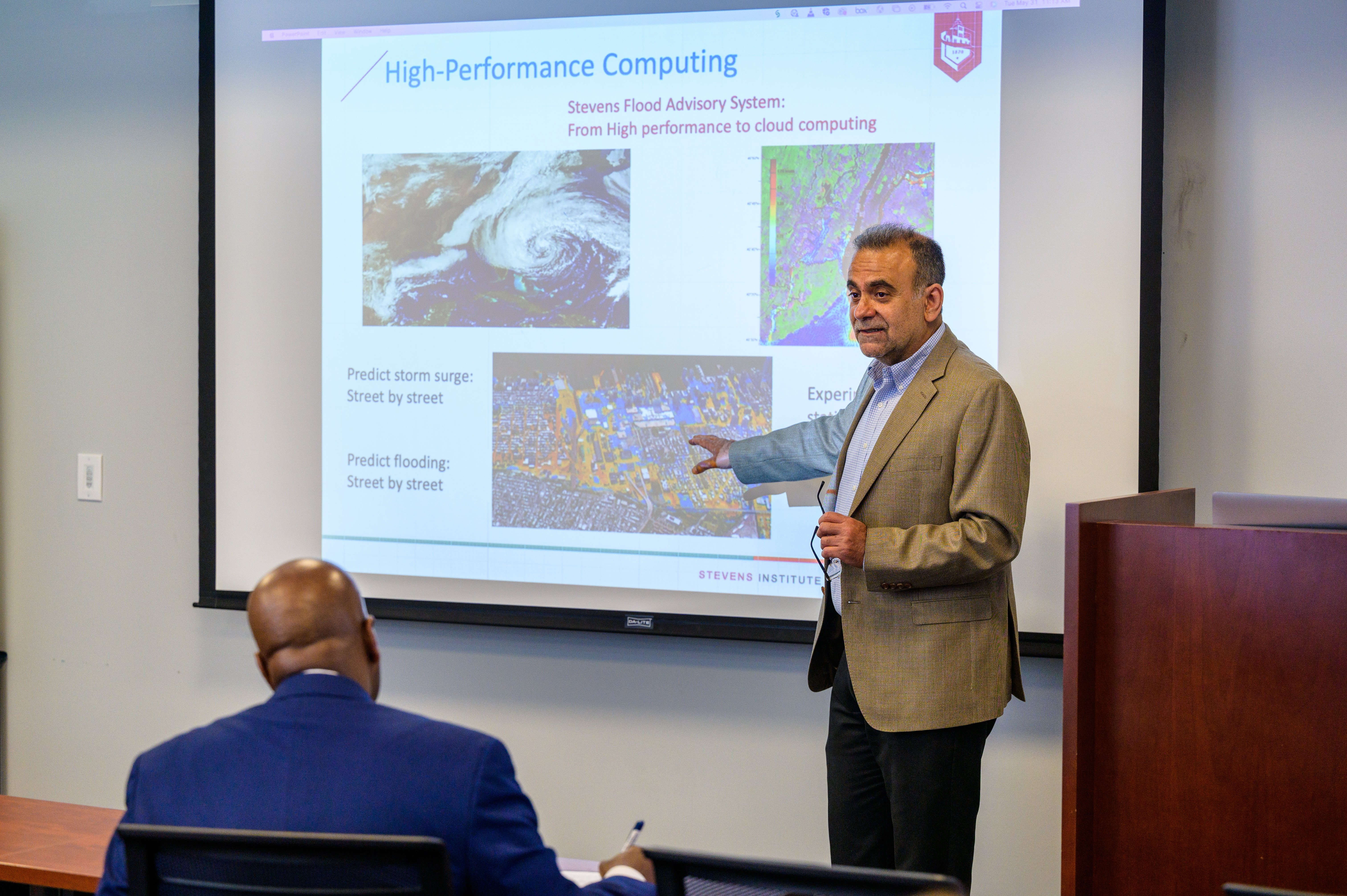 Dr. Muhammad Hajj in front of a whiteboard