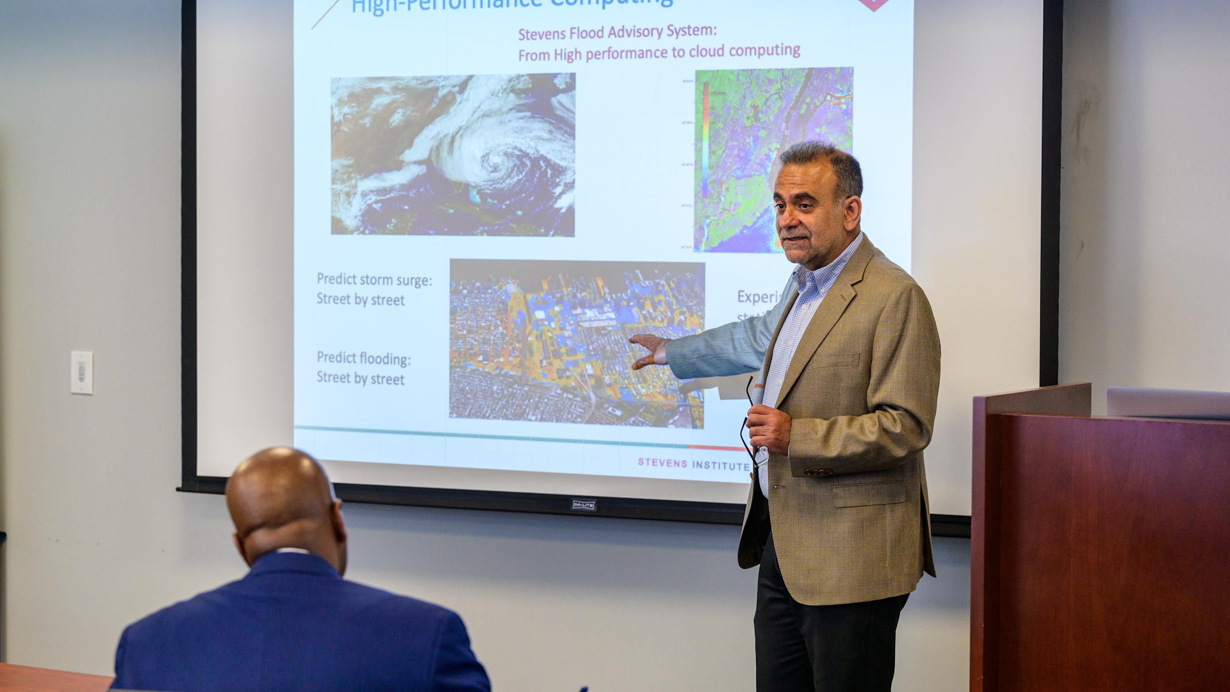 Dr. Muhammad Hajj in front of a whiteboard