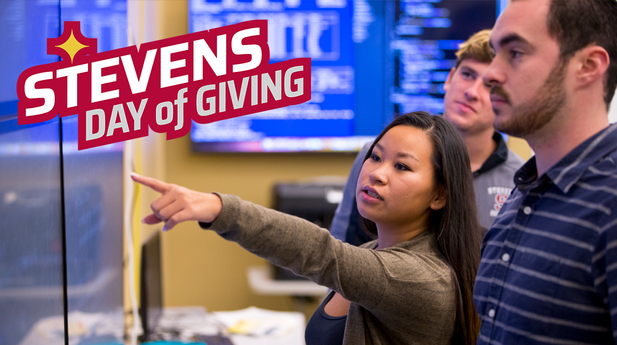 A group of students observe digital screen displaying financial data as one student points out some of the information. 