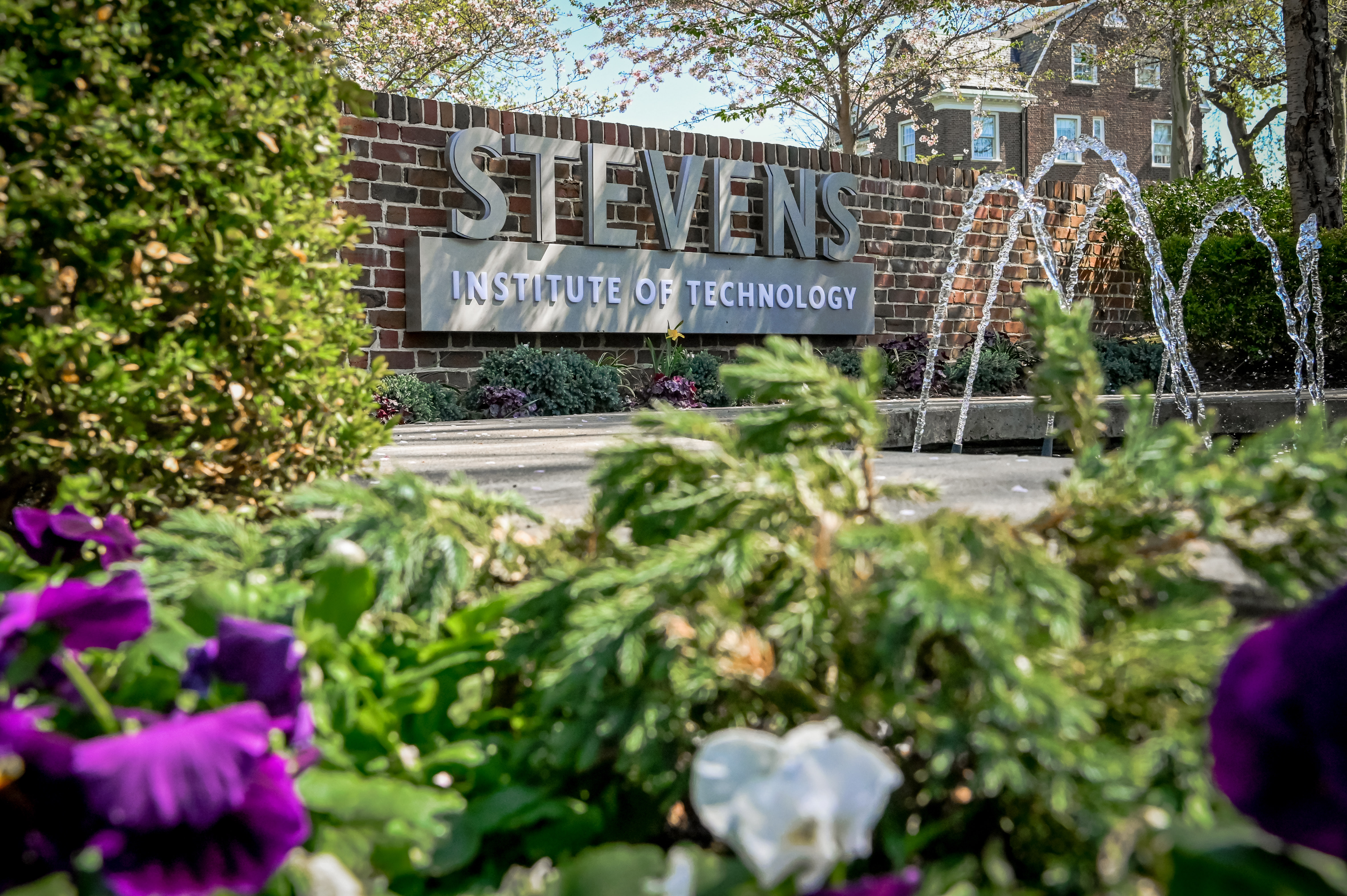 Stevens logo above a fountain and flowers