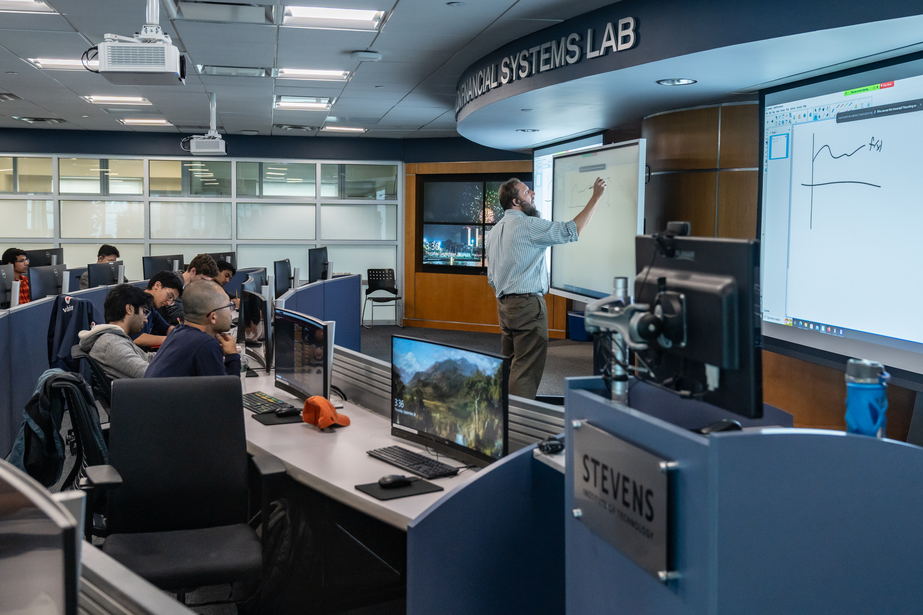 Professor teaches group of students in the Hanlon Lab 