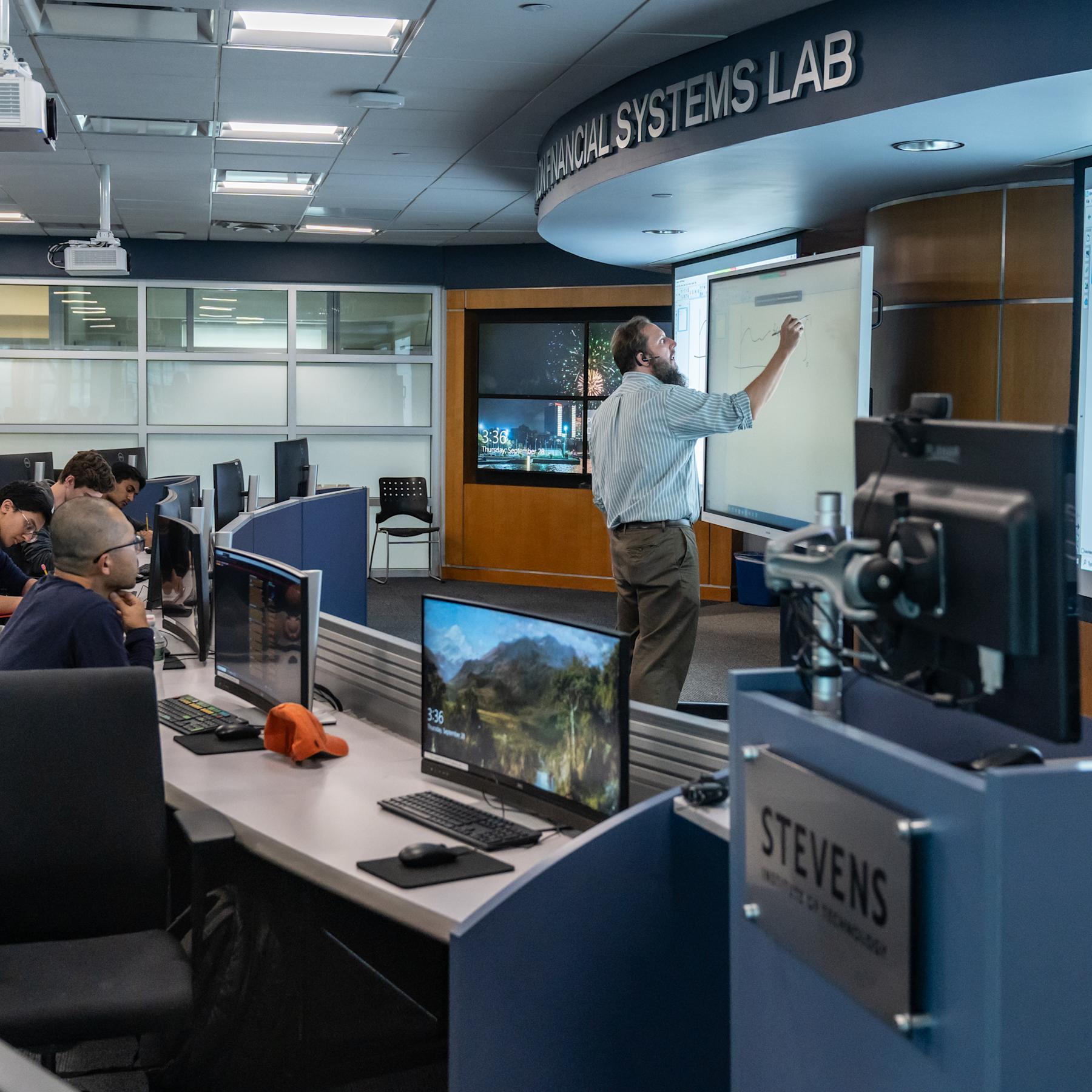 Professor teaches group of students in the Hanlon Lab