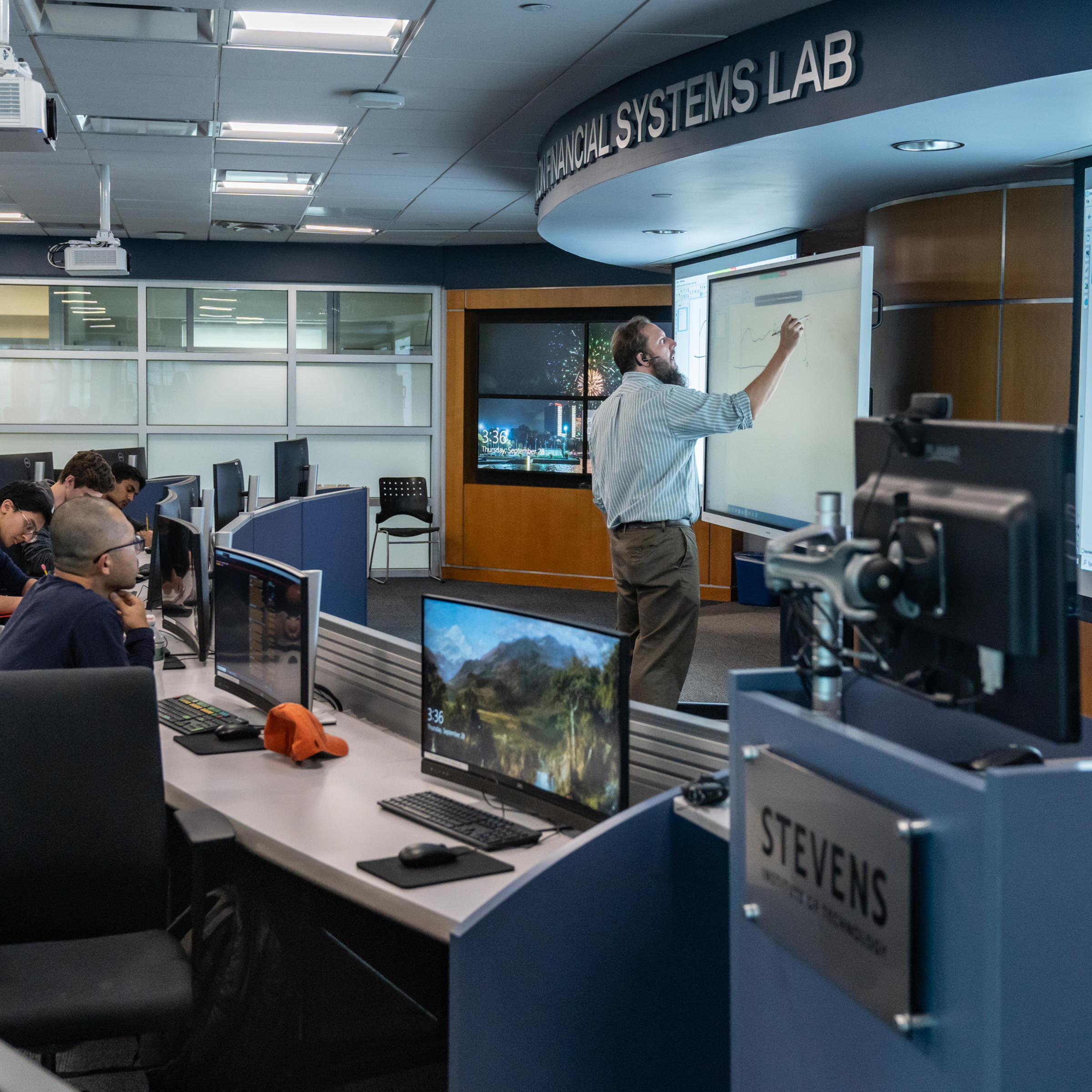 Professor teaches group of students in the Hanlon Lab