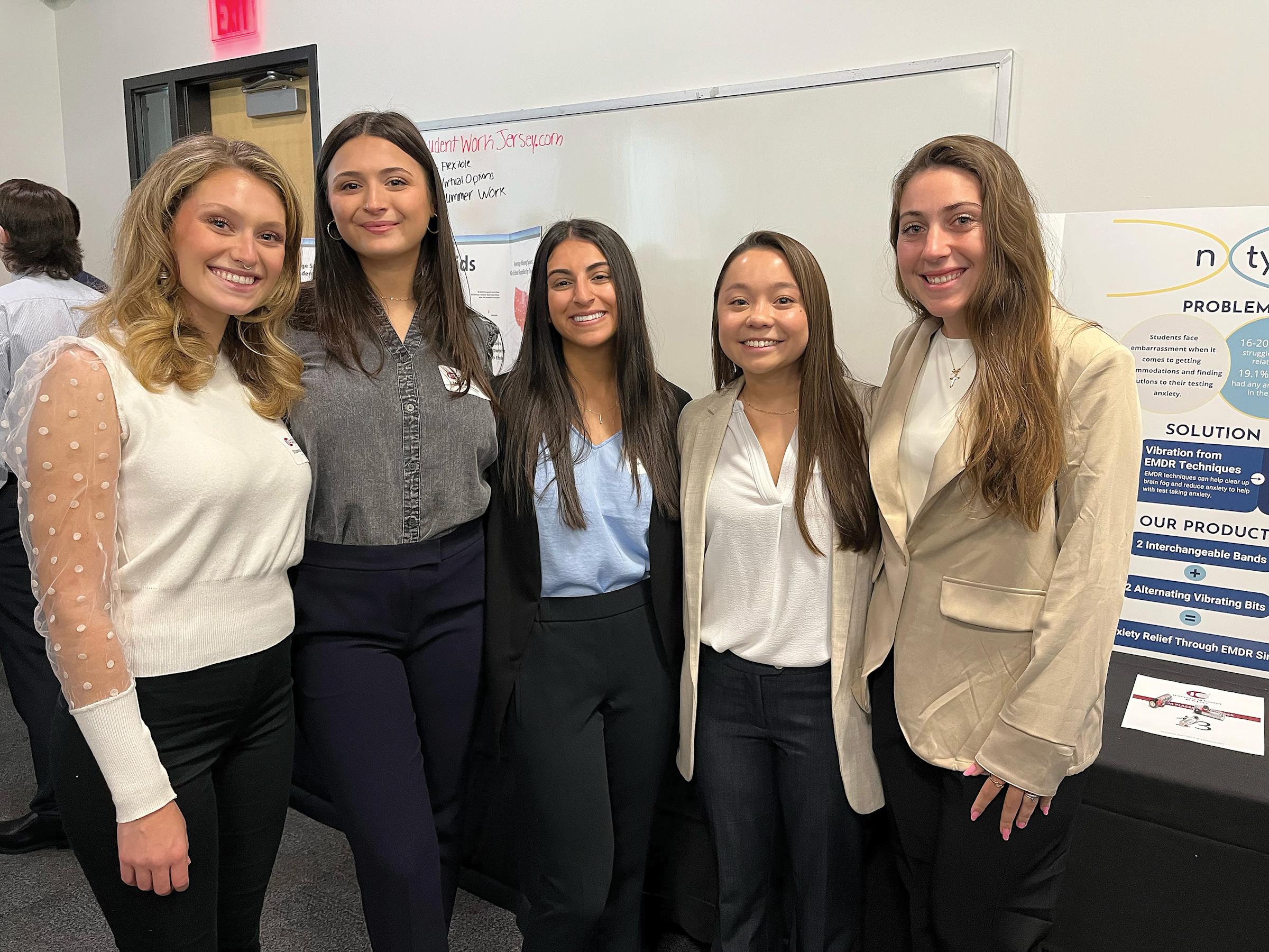 Five Stevens students stand with their presentation at the Innovation Expo.