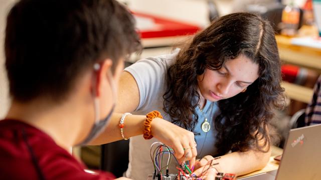 Students work on project connecting wires