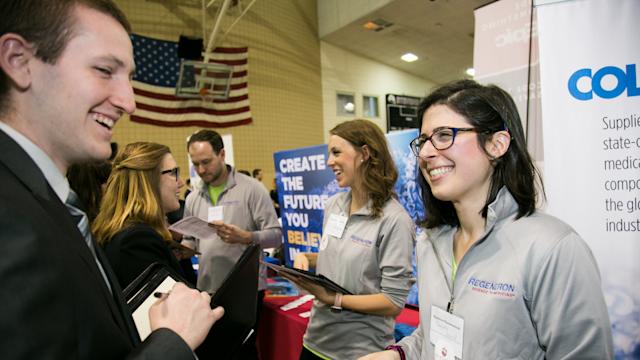 Student speaks with alum at the Career Fair