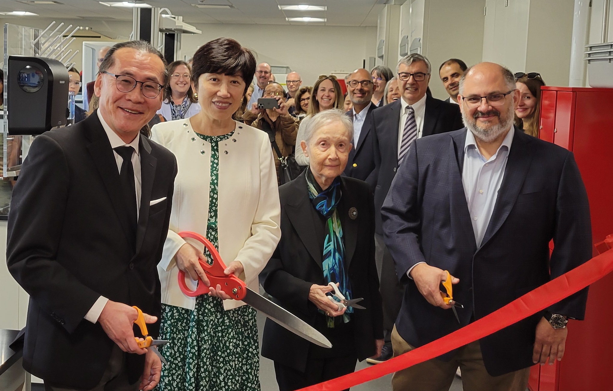 A photo of Professor Woo Lee, Dean Jean Zu, Professor Nuran Kambaraci and Michael Milone ‘93 cutting the ribbon to the new lab.