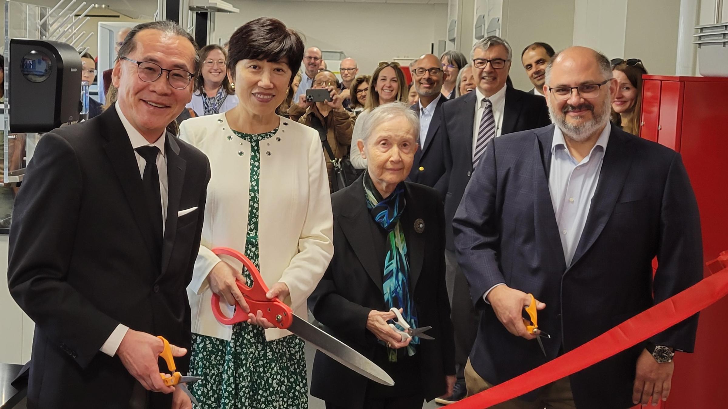 A photo of Professor Woo Lee, Dean Jean Zu, Professor Nuran Kambaraci and Michael Milone ‘93 cutting the ribbon to the new lab.