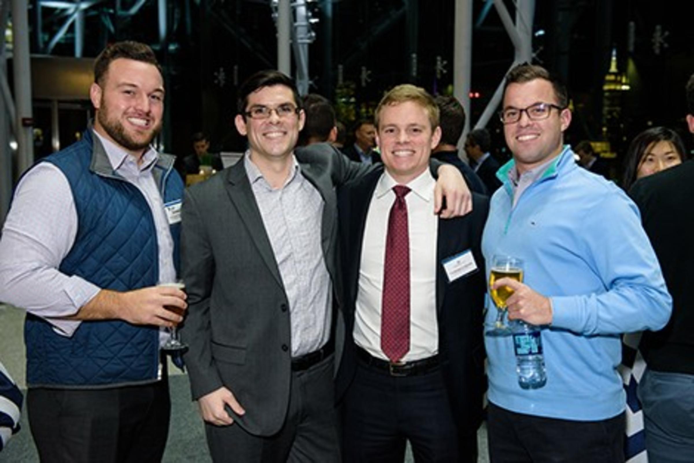 Four students standing at network event