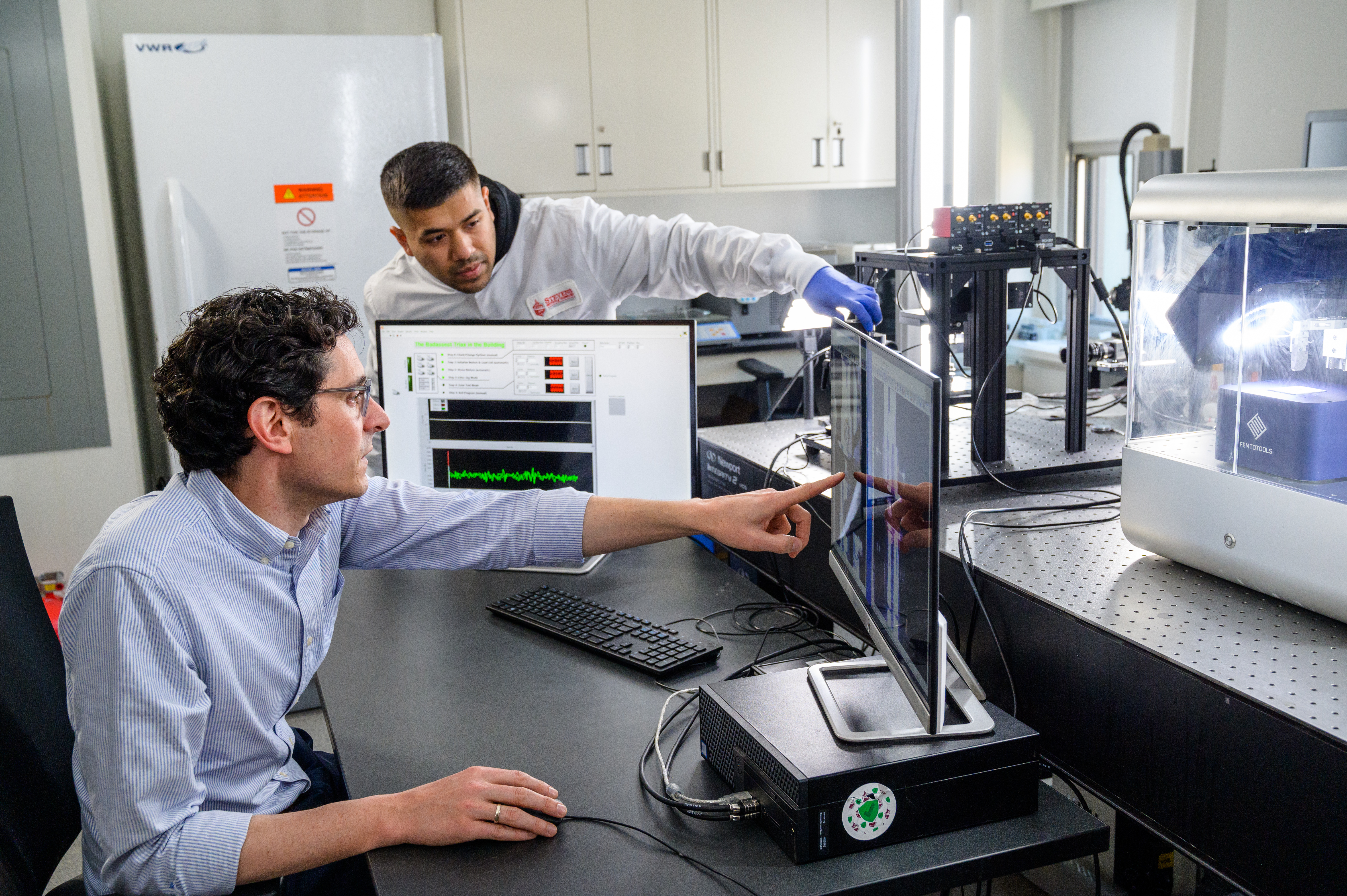  A professor and research assistant view findings on a computer.
