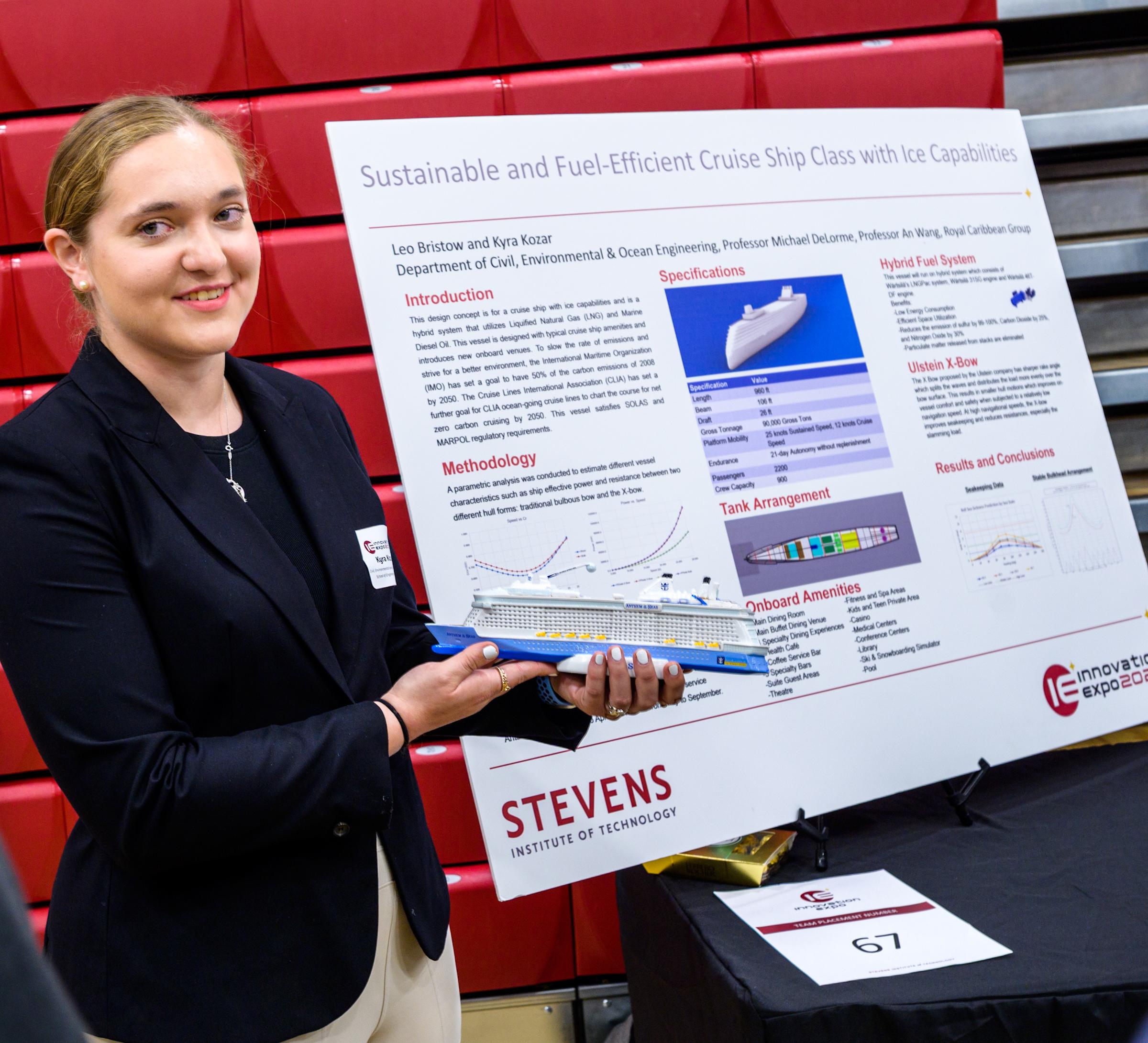 Female team member holding small cruise ship model at Stevens' 2023 Innovation Expo