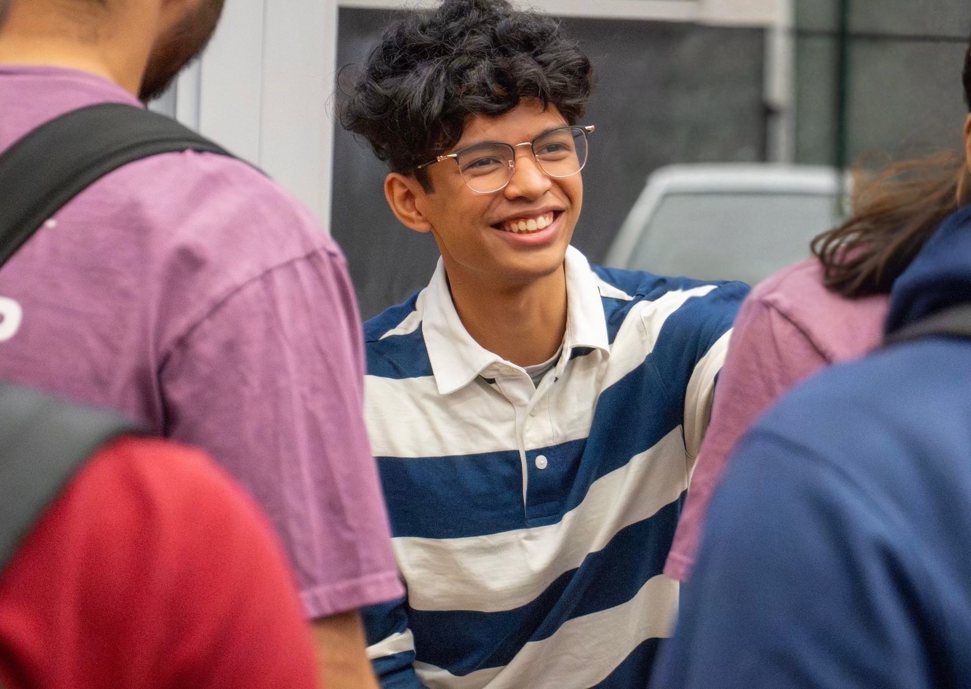 Ouckama smiling at a Stevens' career panel with other students nearby