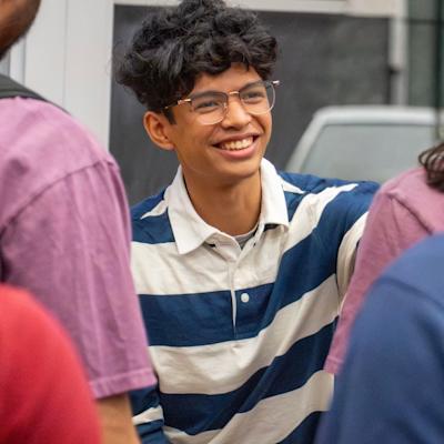 Ouckama smiling at a Stevens' career panel with other students nearby