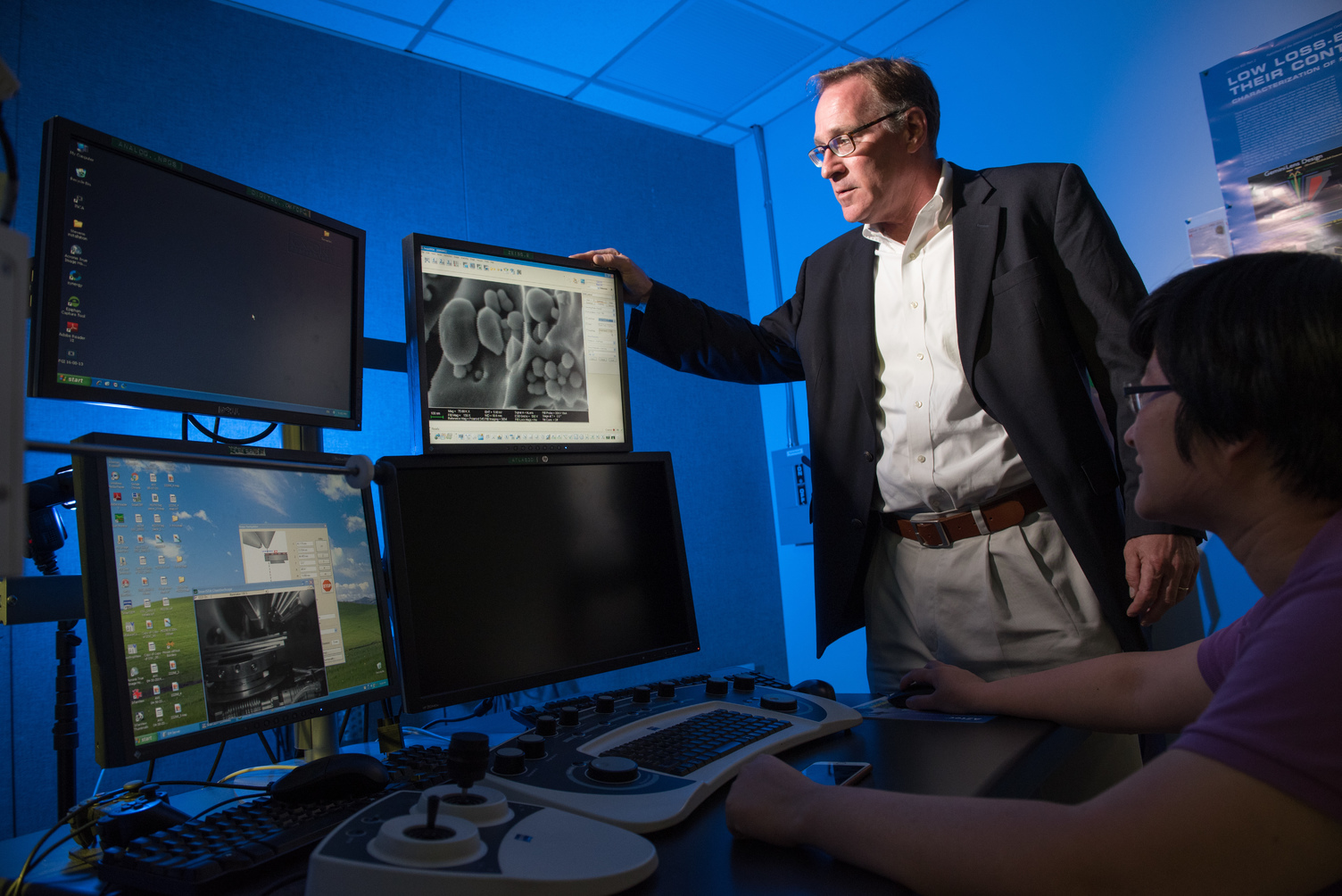 Professor Matt Libera looks at a computer monitor. 