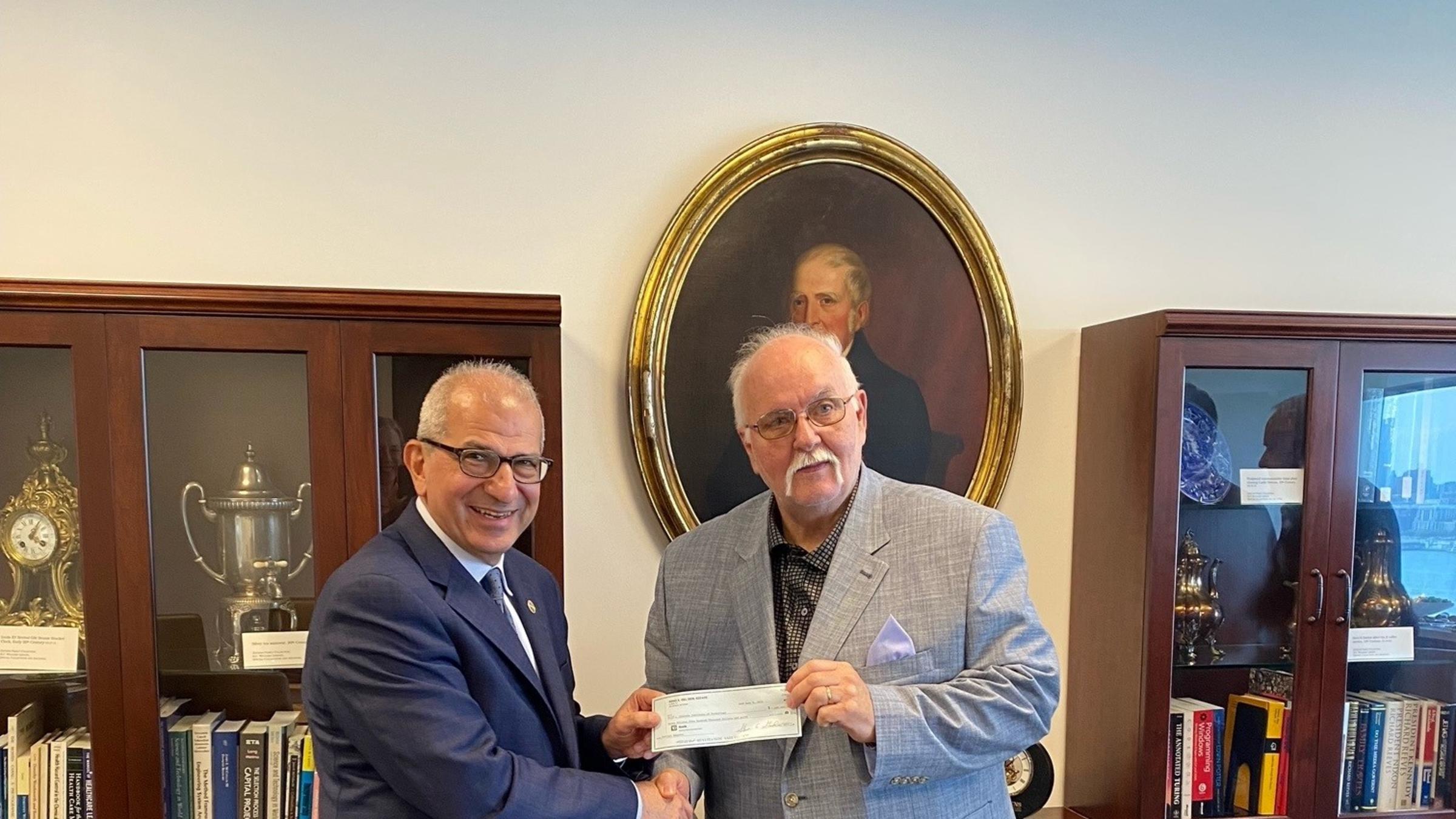 President Nariman Farvardin with Steve Standler, executor of the estate of Reno Del Ben ’58.