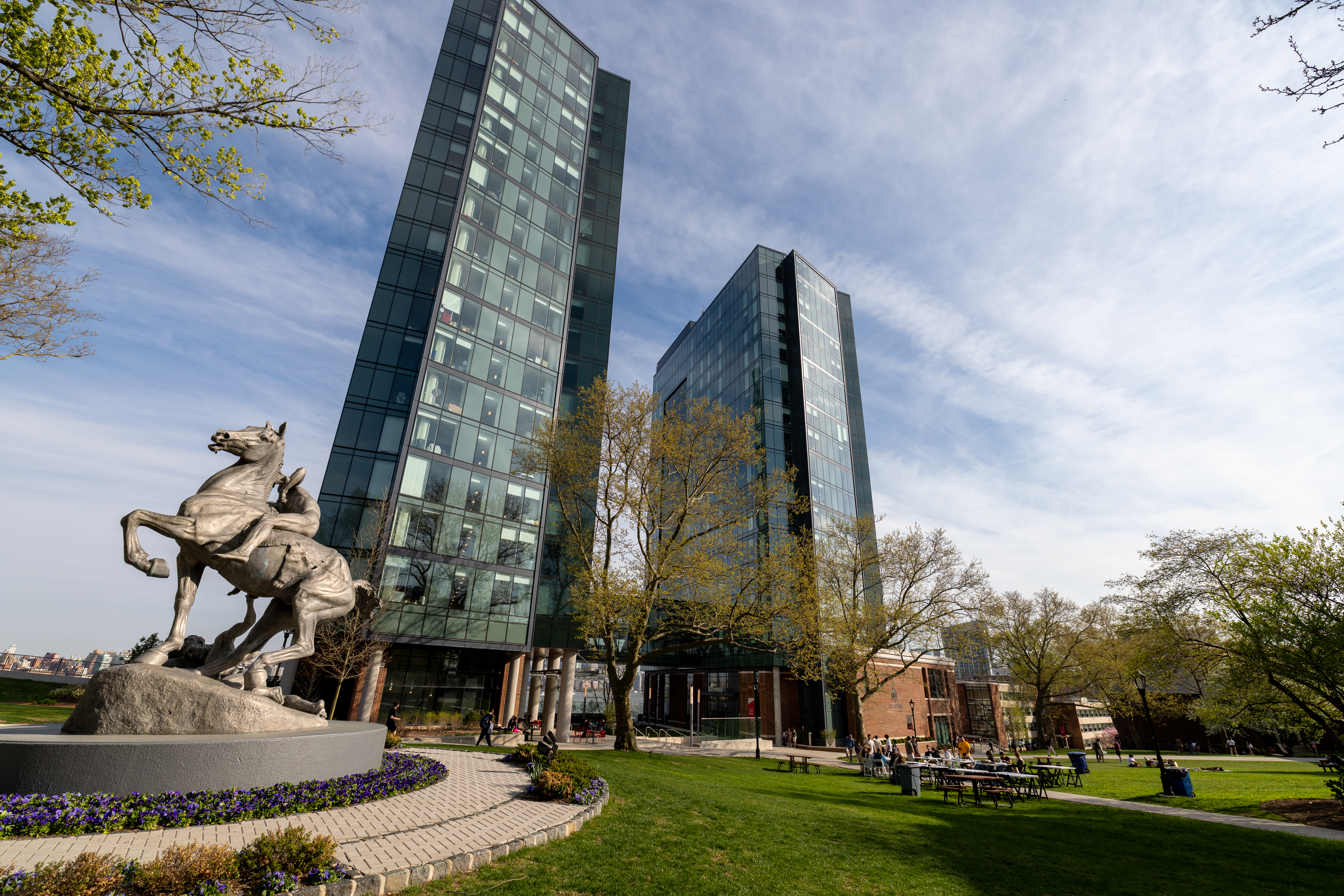 A horse statue in front of two glass skyscrapers