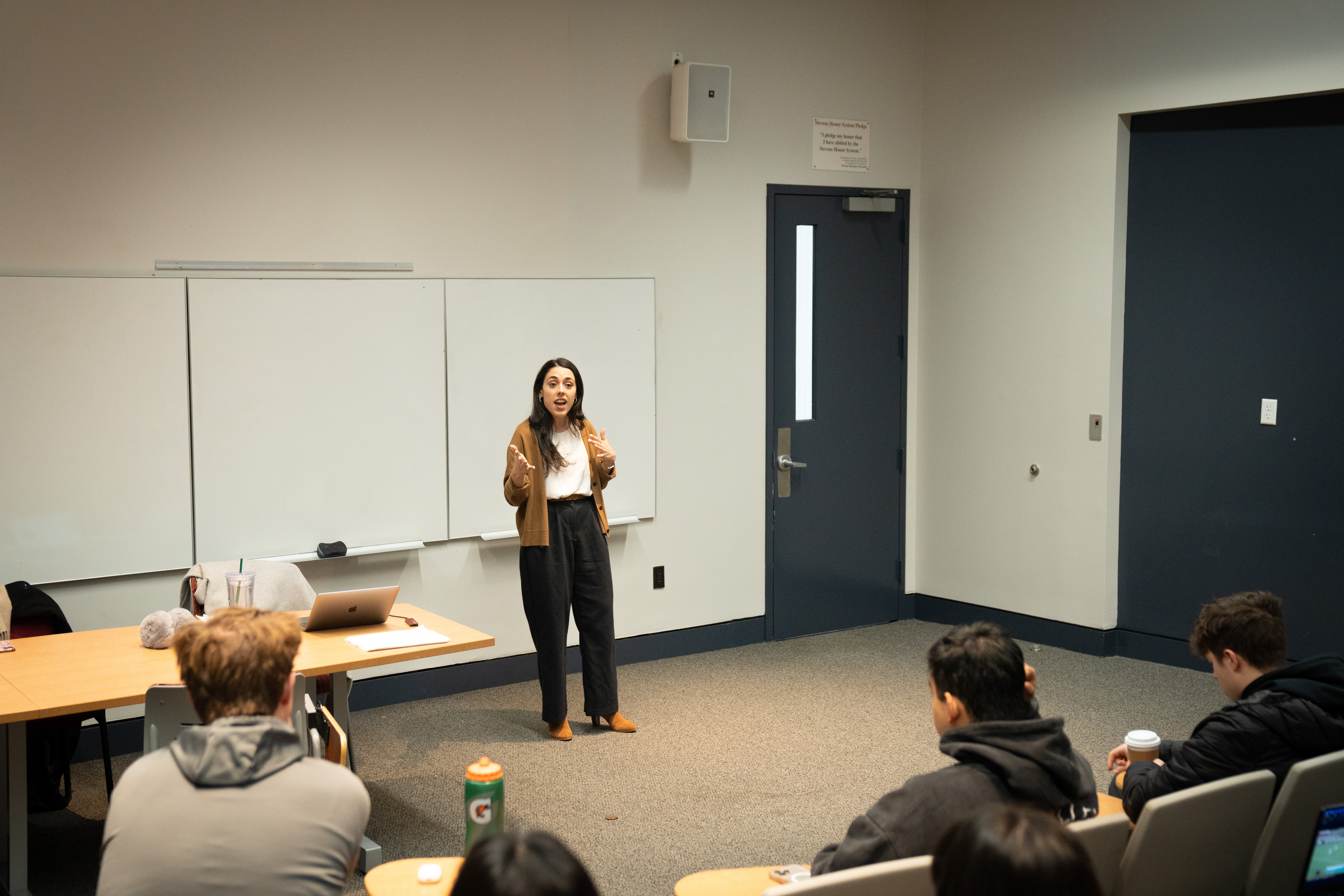 Allie Masciana stands in front of a class and speaks to students.
