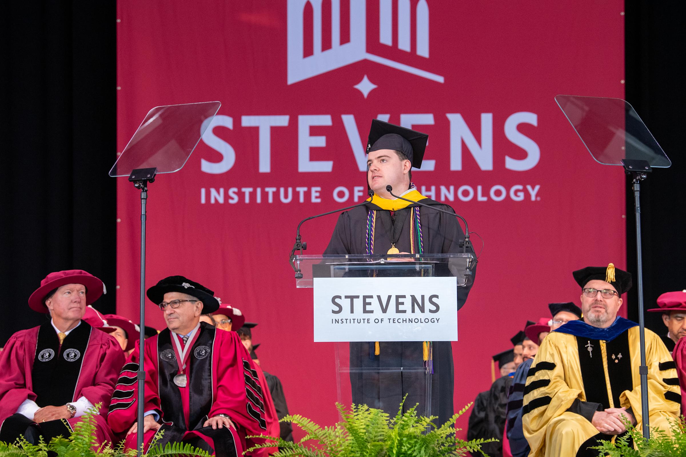 Undergraduate Commencement Speaker Robert Dahill speaks to the crowd from the podium.