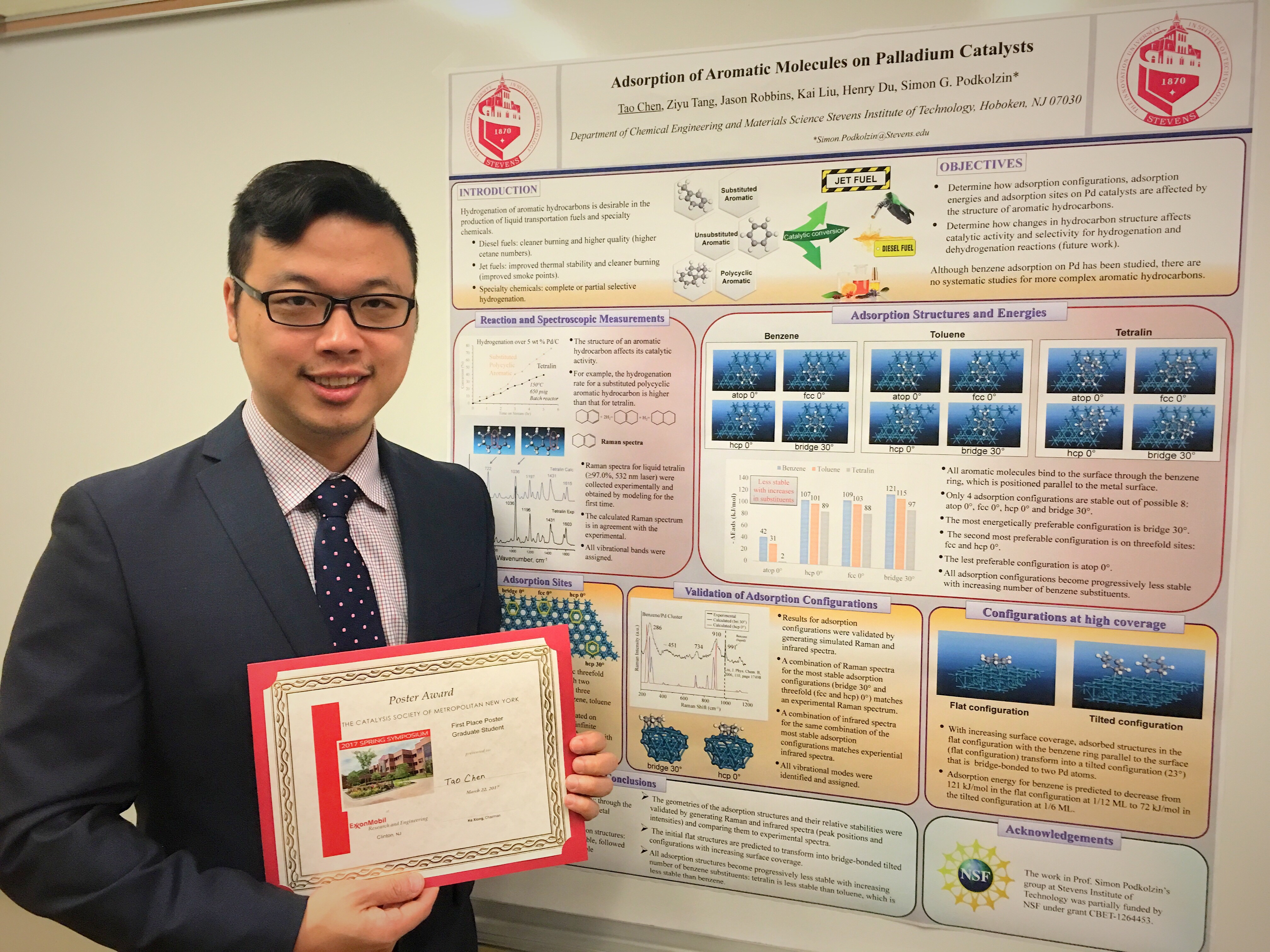 Tao Chen holding award in front of poster