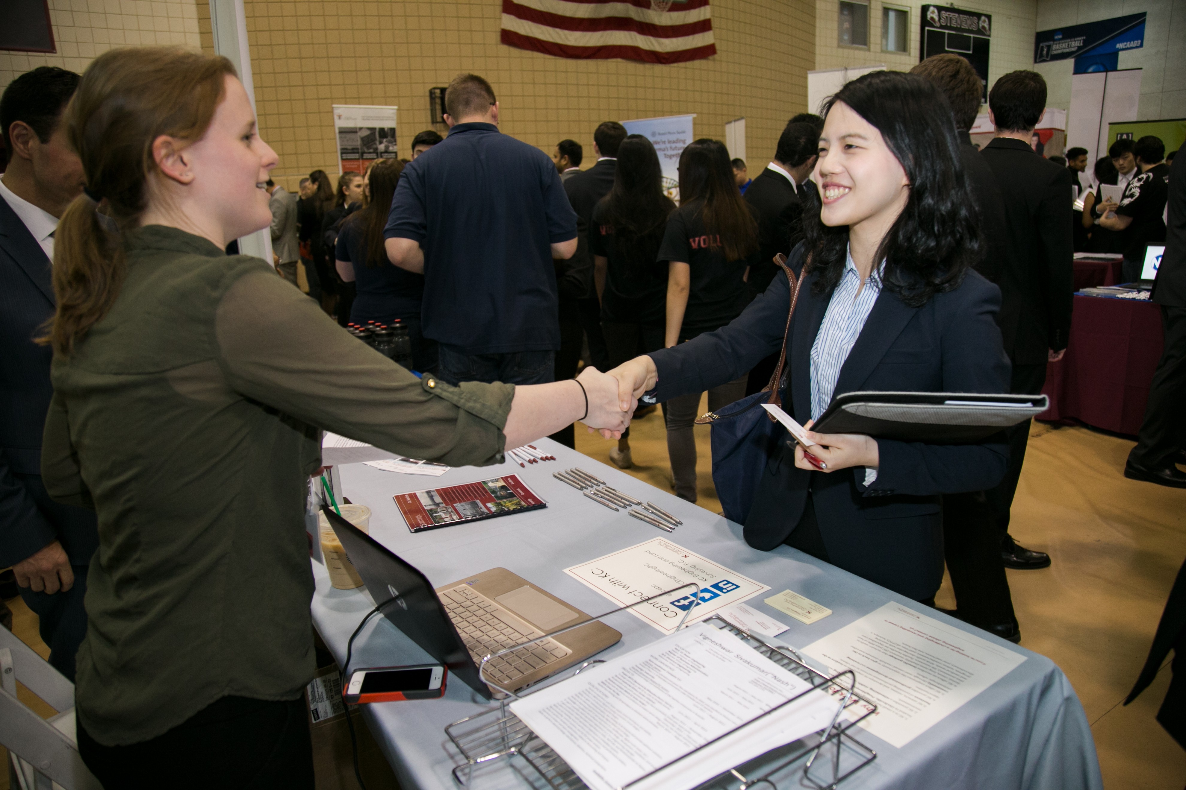 2 females shaking hands at Career Fair