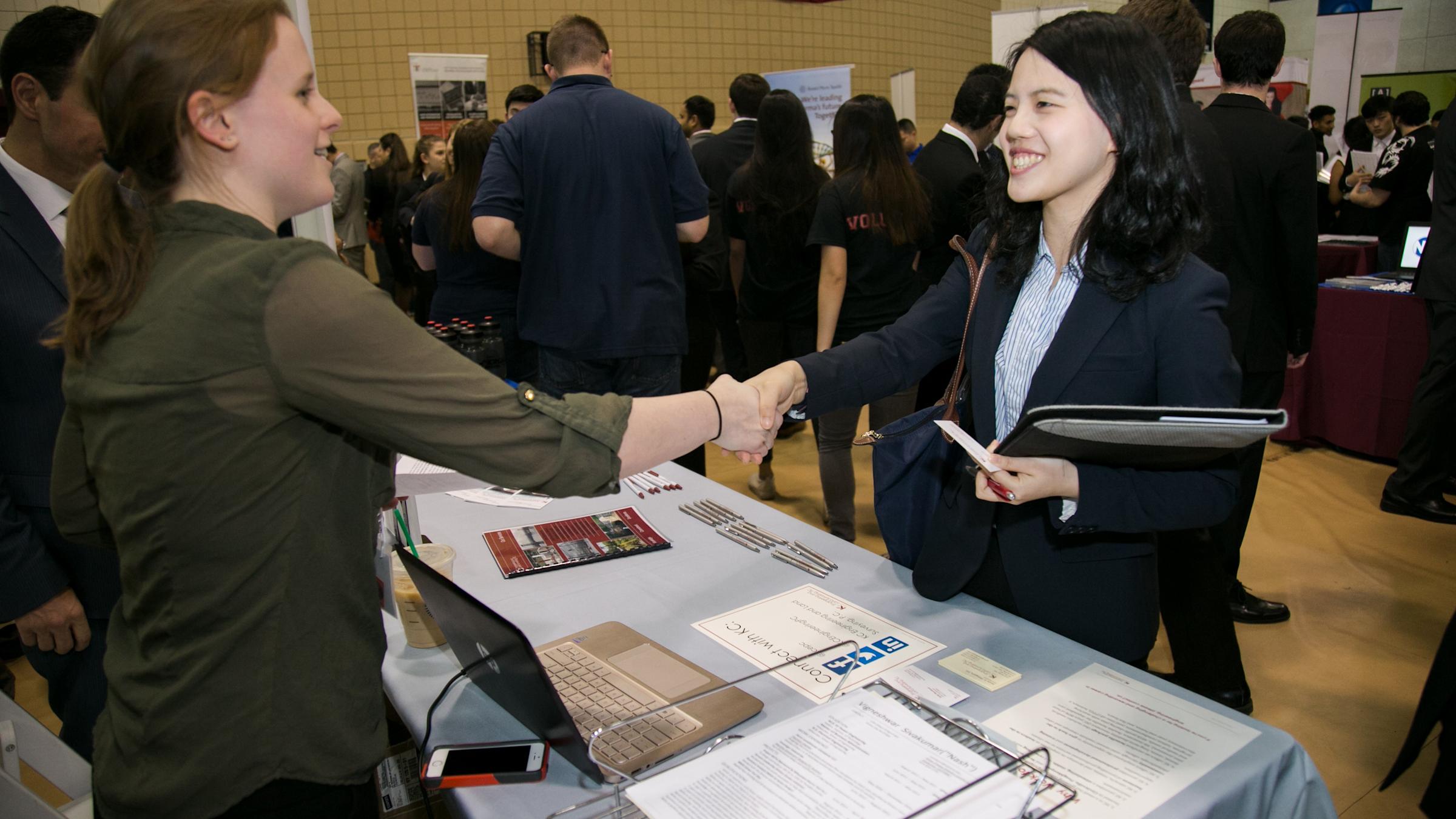 2 females shaking hands at Career Fair