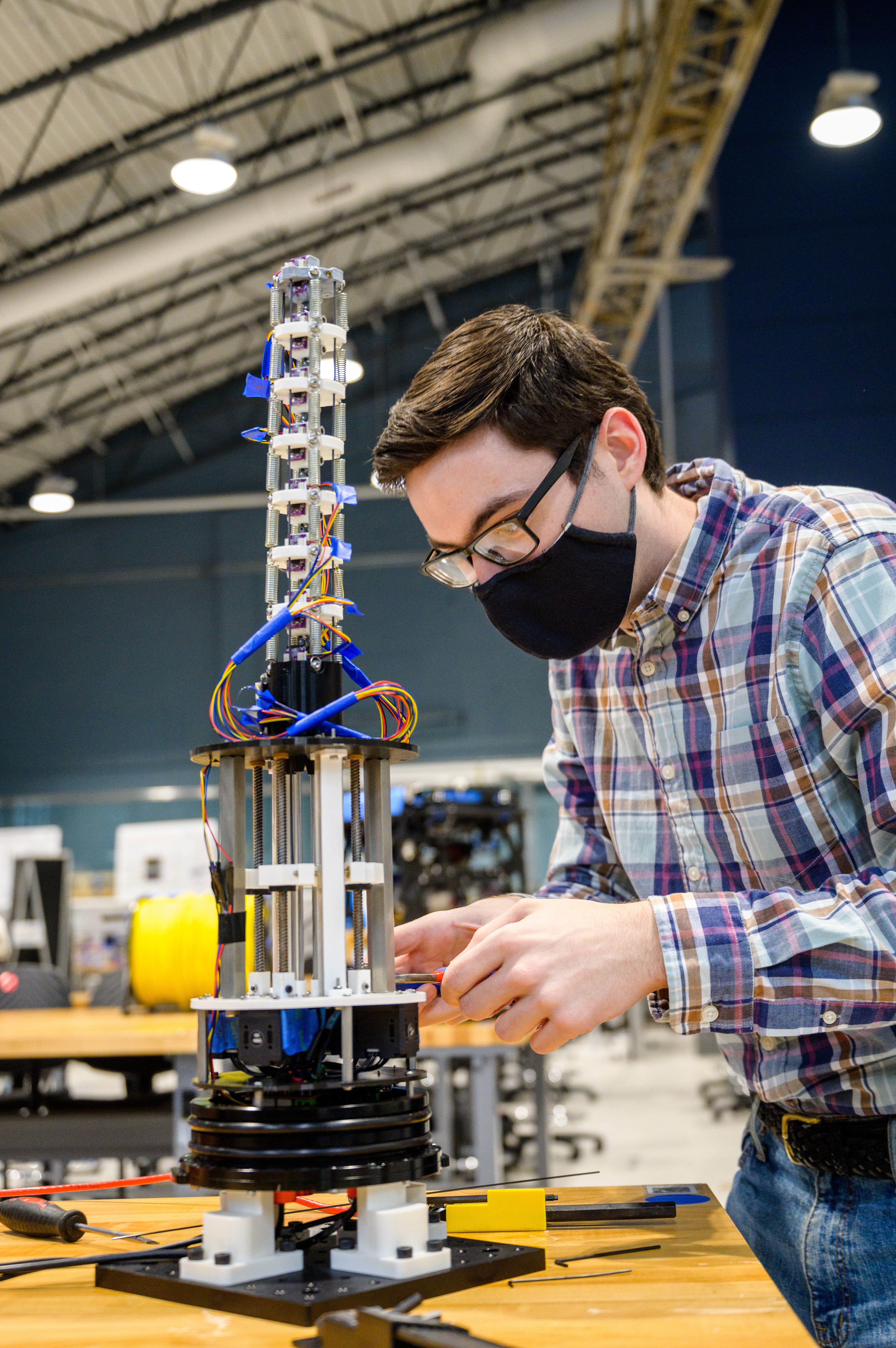 student working on robotics project in lab